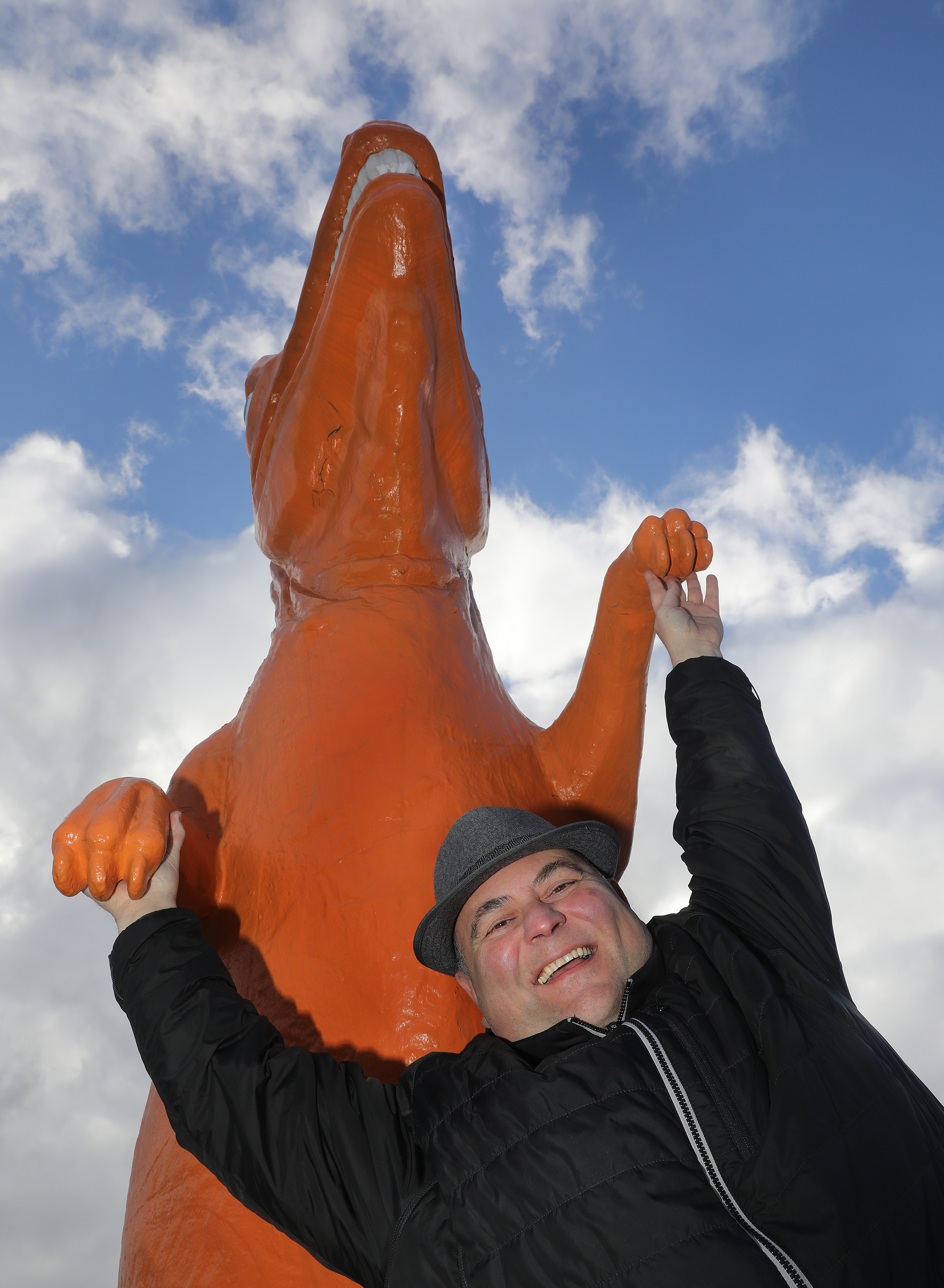 Co-owner and president Paul Delios in front of the orange dinosaur in Saugus where Kane’s Donuts is opening a new location.