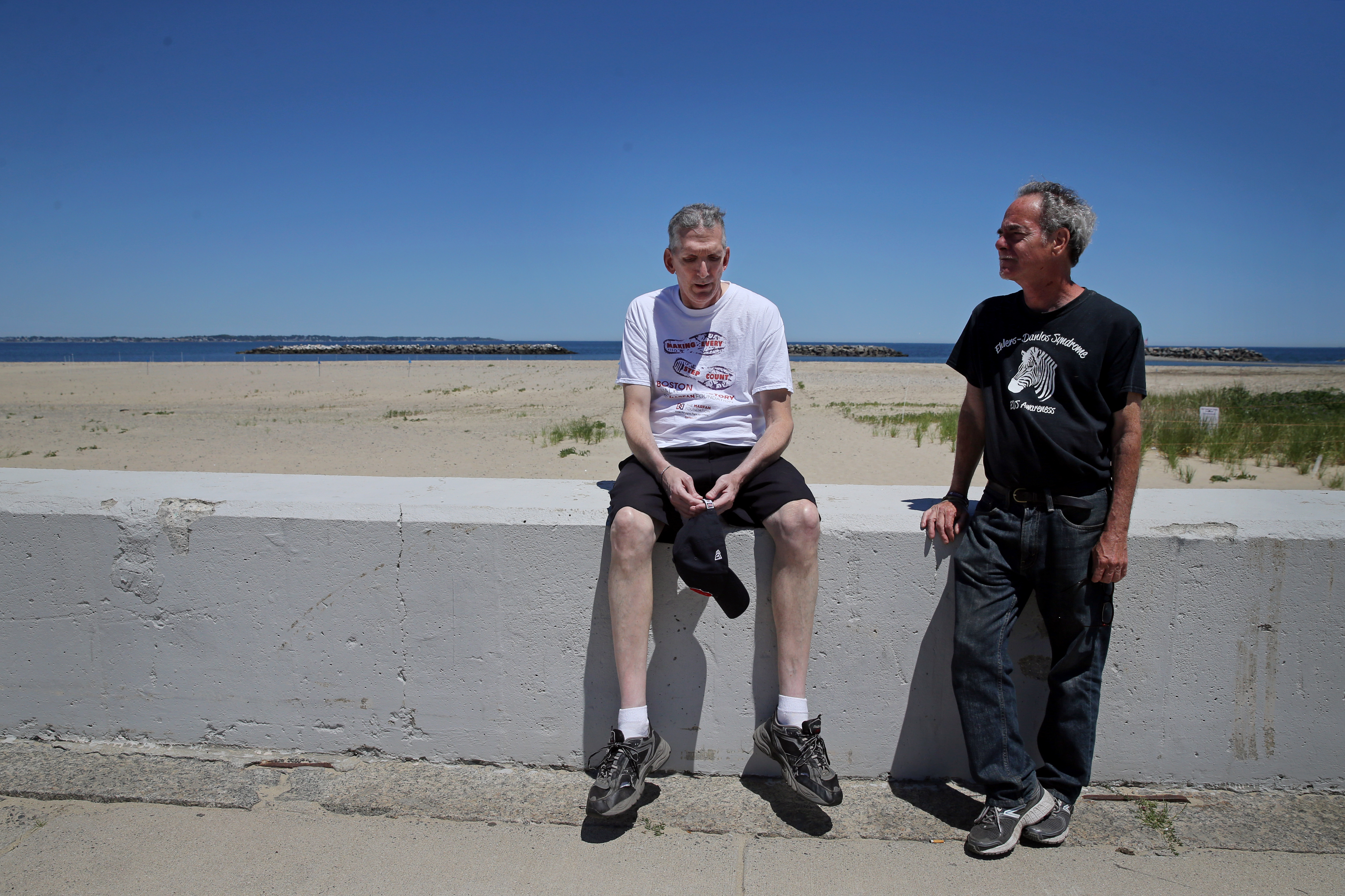 Joathan Rodis (left) made a rest stop during a walk in Winthrop with his longtime friend, Lloyd Caplan. Rodis has Marfan syndrome, a genetic disorder.