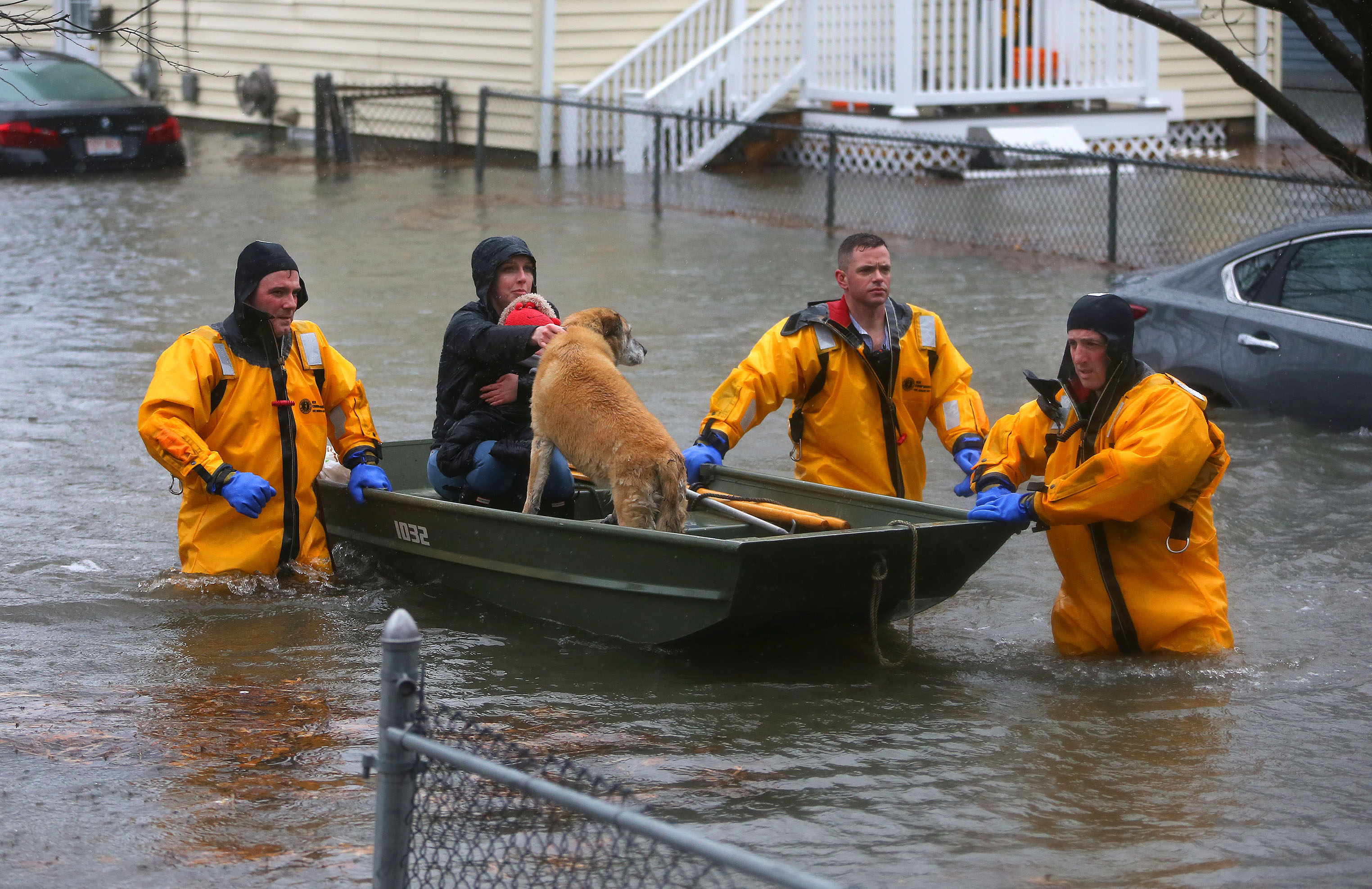 A mother, child, and dog were rescued from a flooded home on Post Island Road in Quincy on Friday.