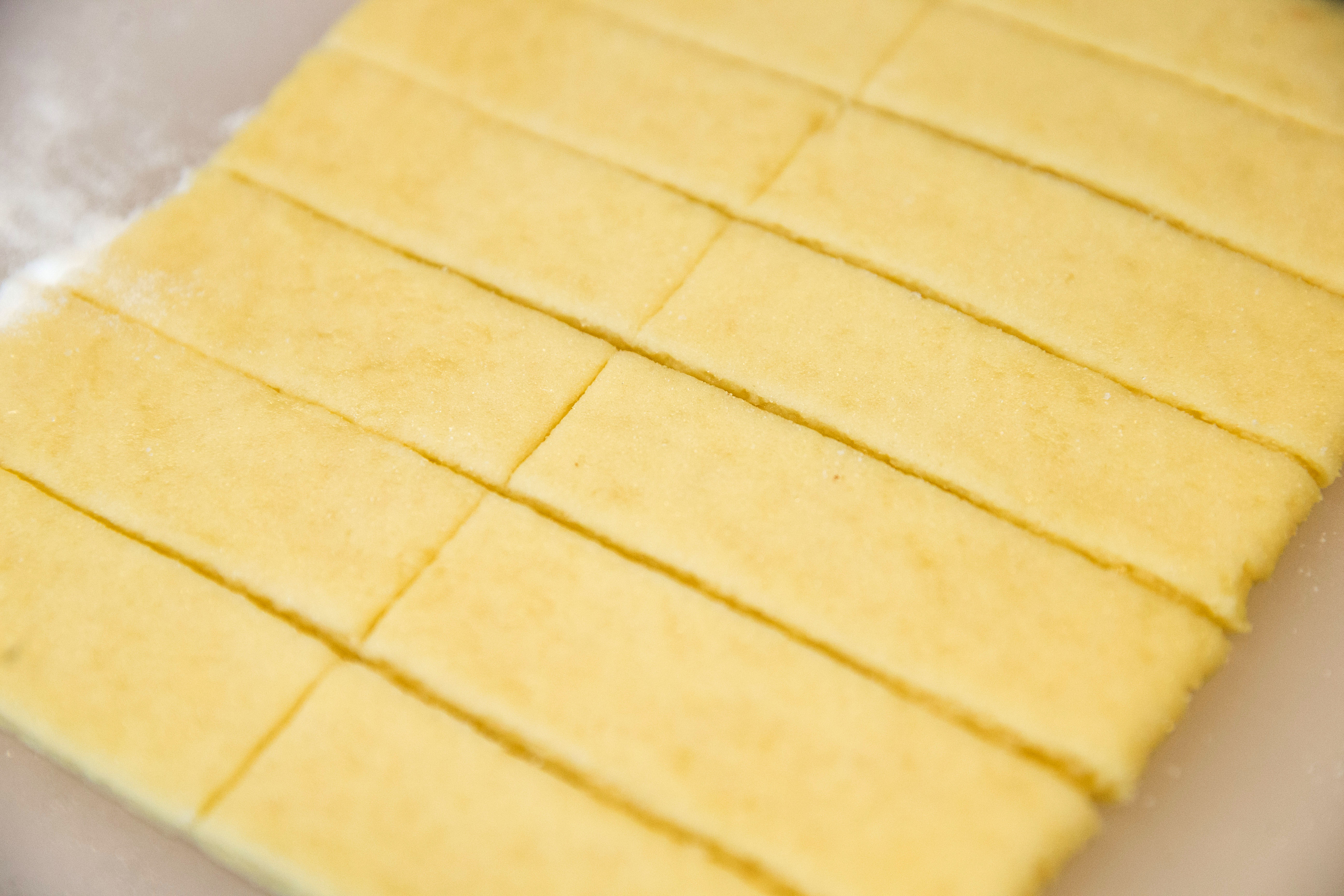 Cutting the dough for caramel-sugar pufflets.