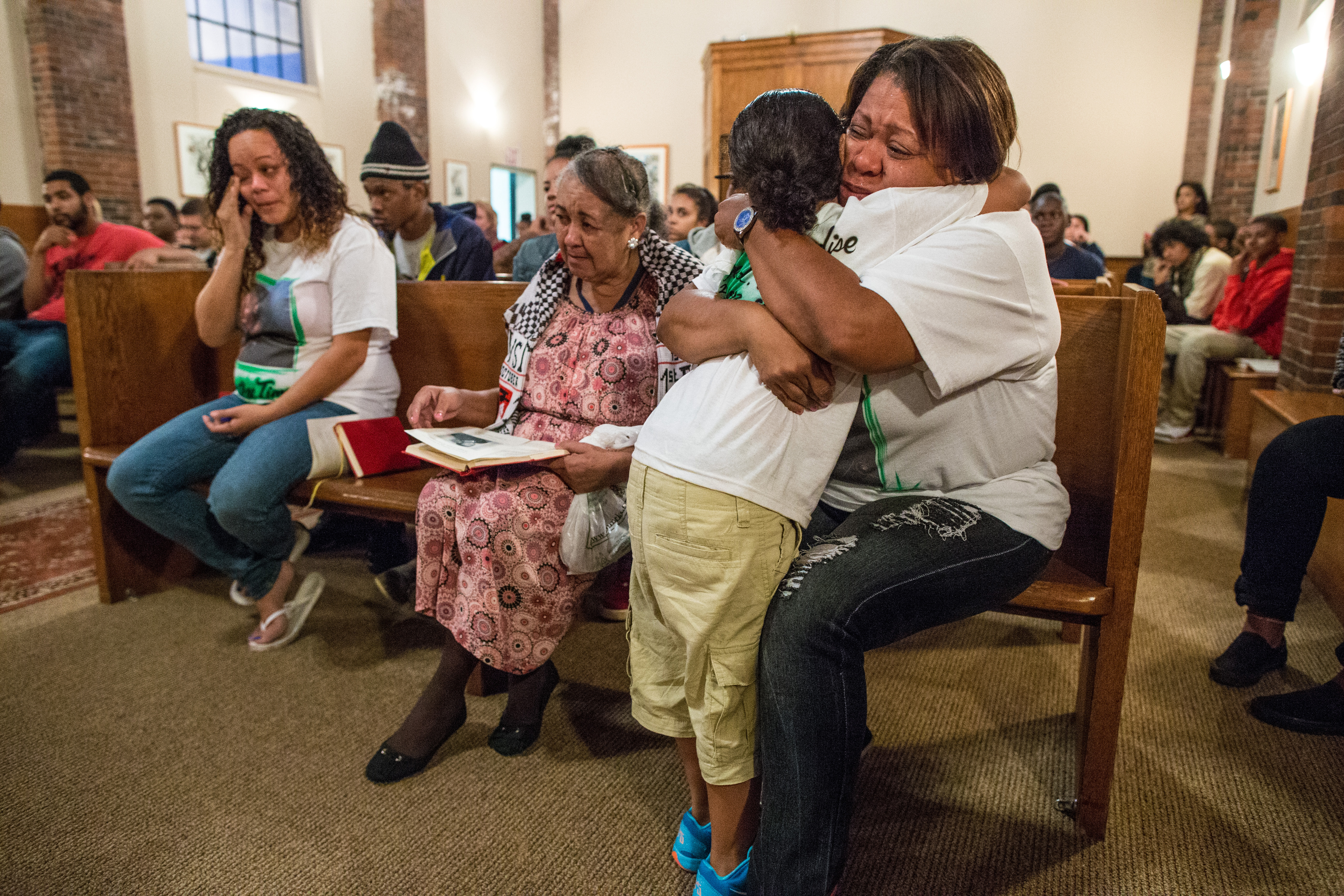 Mirnaluz Ramos hugged her grandson Luis Fuentes, 6, during a memorial last month honoring the memory of her son, Jorge Fuentes, who was shot dead just over a year ago.