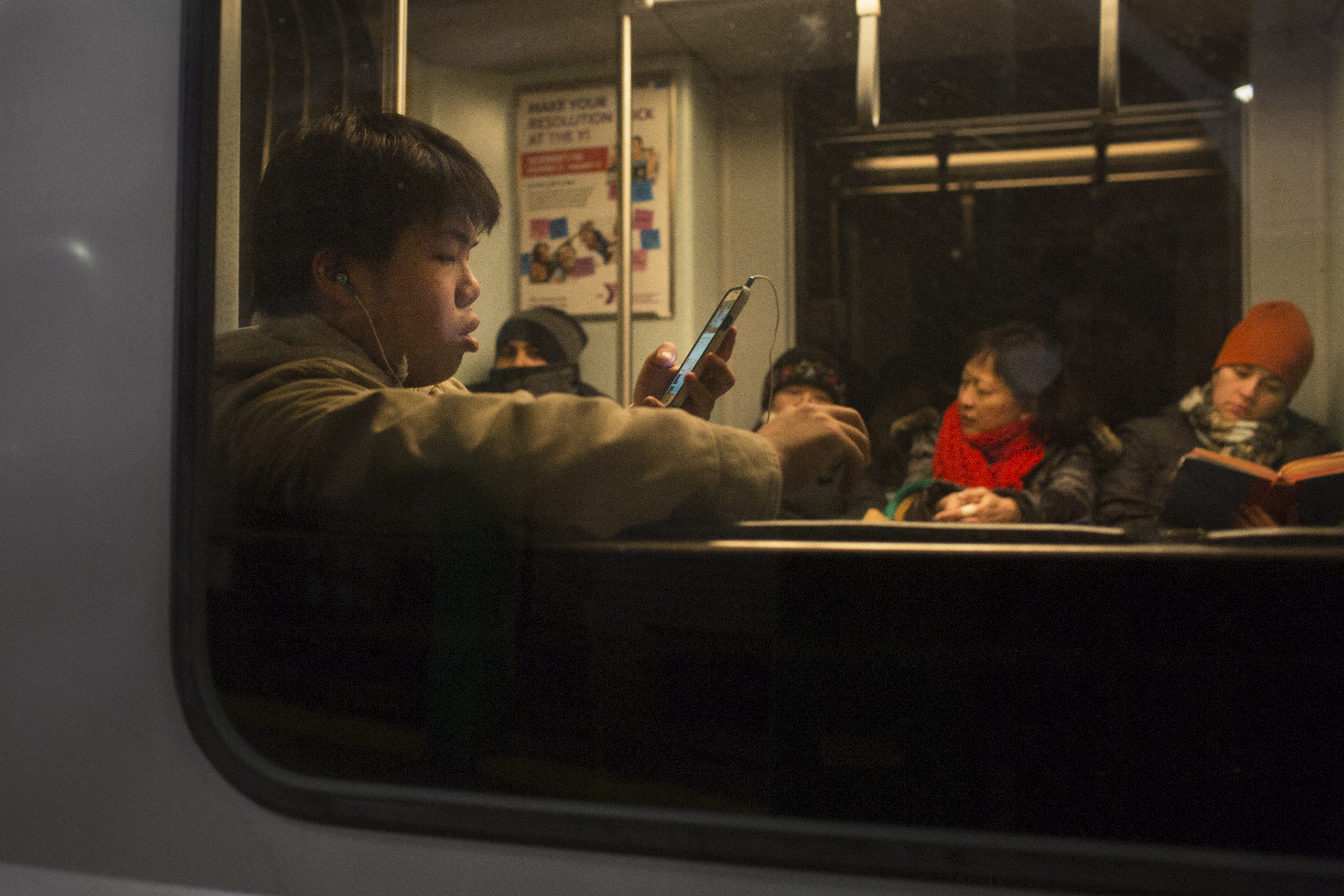 Commuters passed the time riding the T late at night last year.