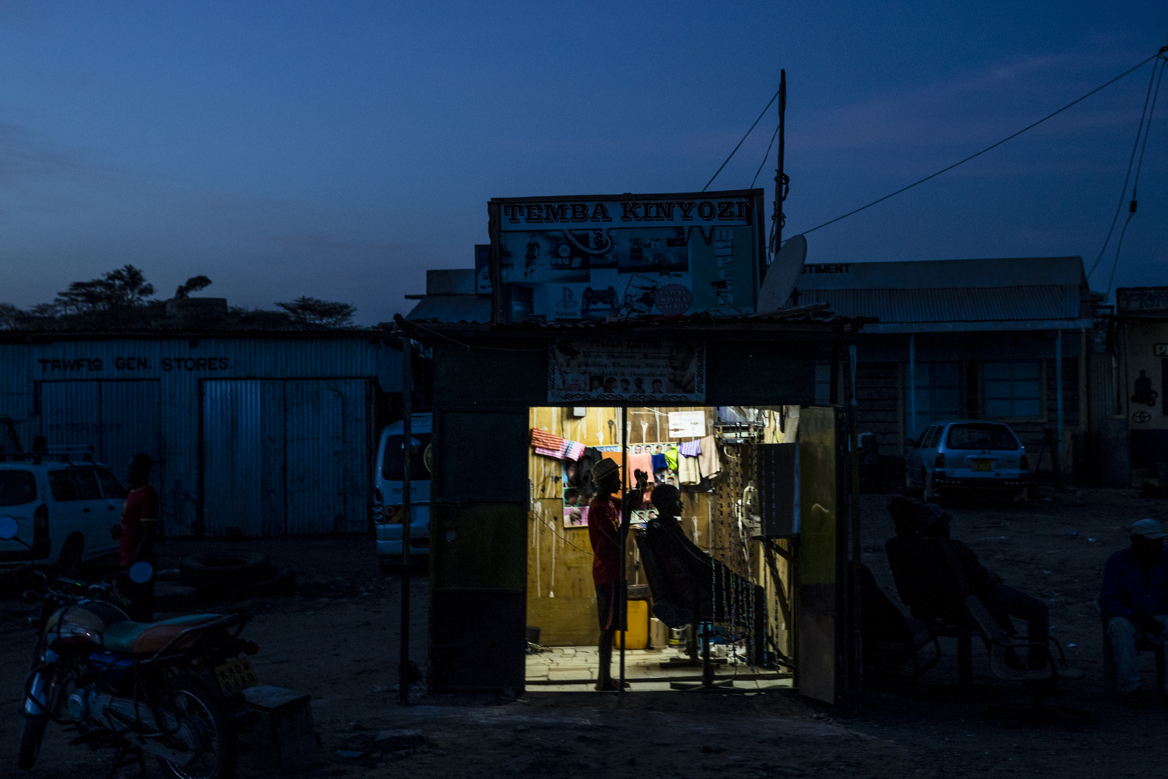 A barber cut a resident’s hair at a small shop in the UNHCR refugee camp.