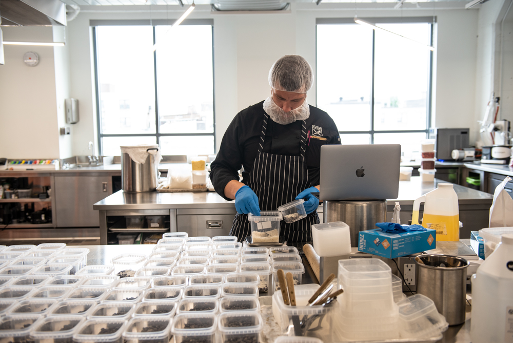 Scientists in white lab coats and chefs in black aprons work together at Chew conjuring up recipes for more healthful foods, beverages, and snacks.