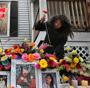 Binland’s mother, Mei, above, and other family and friends returned to 87 Linden St. on the one-year anniversary of the fire, building an elaborate memorial with candles, hazelnut chocolates, teddy bears, and dozens of flowers surrounding three framed photos of Binland.