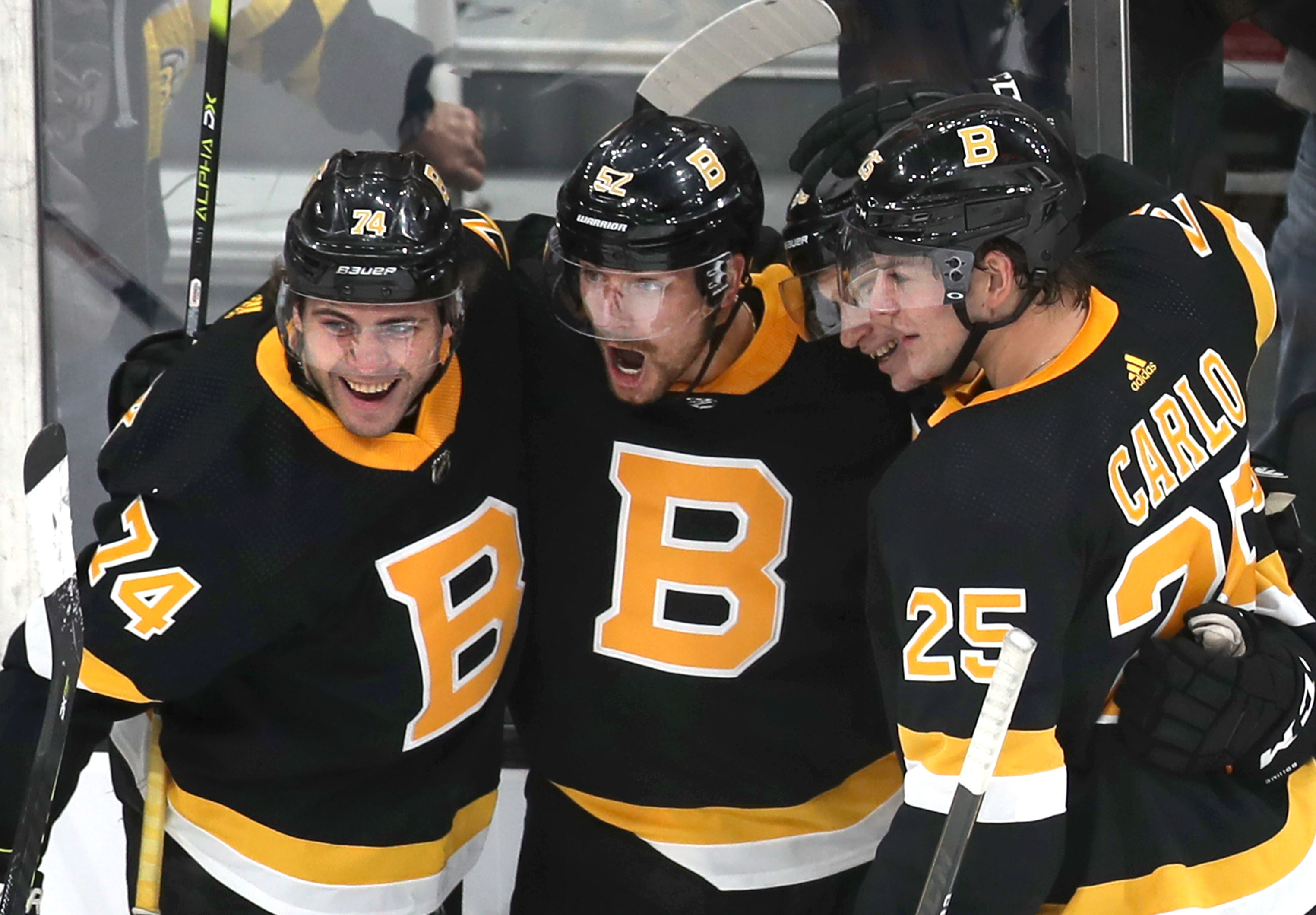 Brandon Carlo (right) has felt plenty of support from teammates like Sean Kuraly (center) and Jake DeBrusk (left).