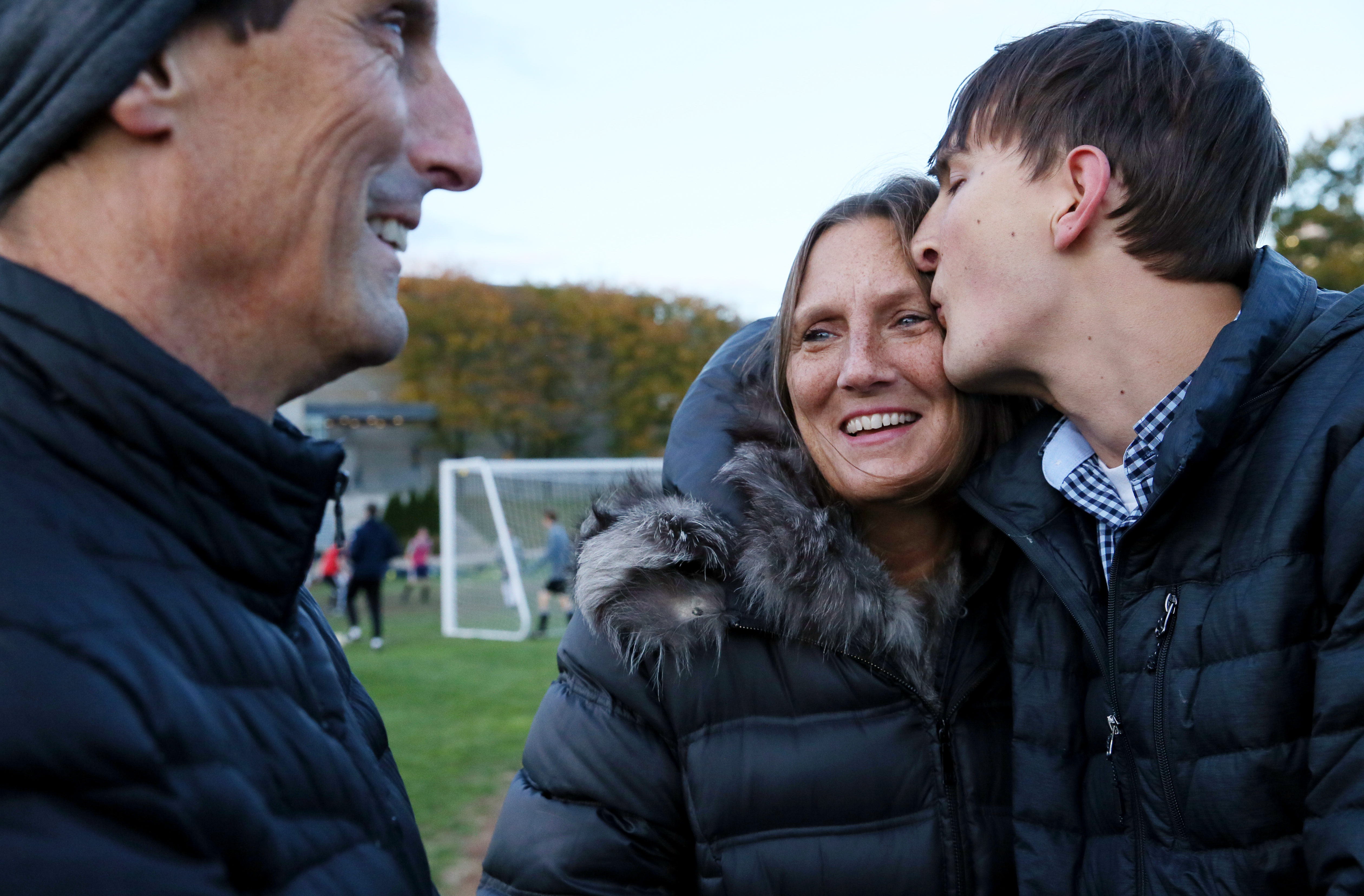 Former BB&N football player Zach McLeod shares a moment with his parents, Pat and Tammy, during practice at the school.