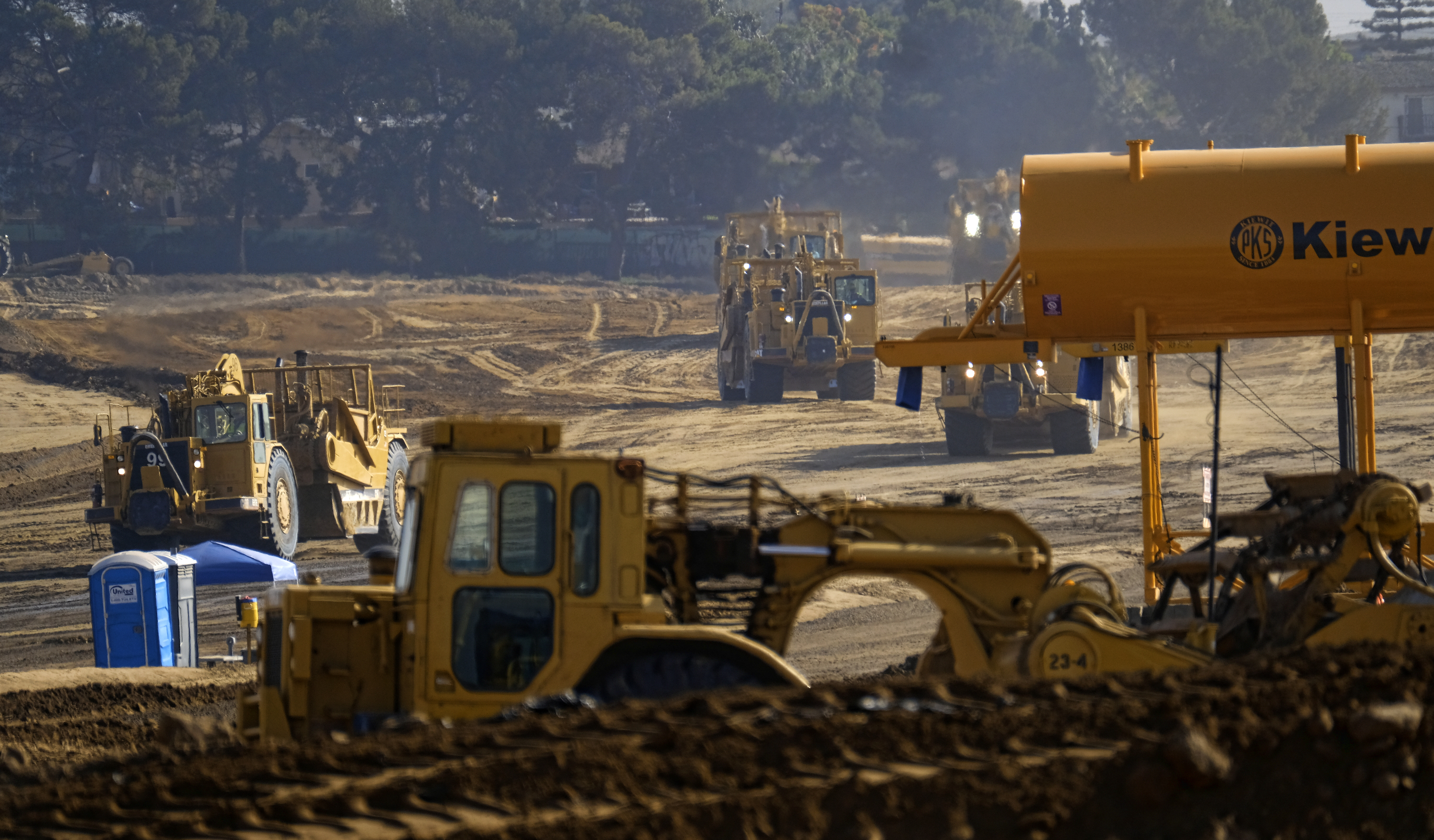 Earth movers clear an area where the new stadium is being built in Inglewood, Calif.