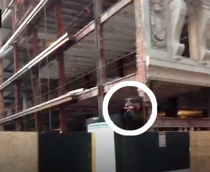 A video screen grab shows a small drone (circled) buzzing around the Filene’s site earlier this month.