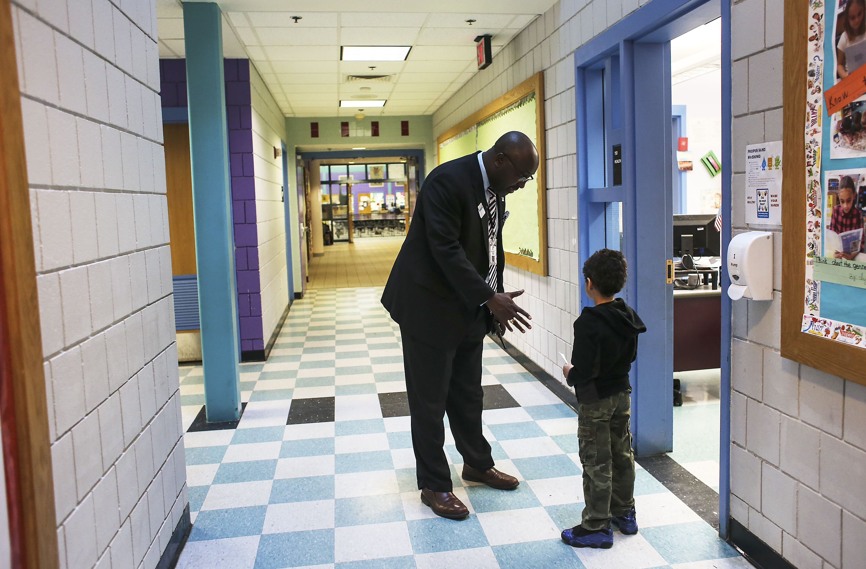 Haverhill schools administrator Rashaun J. Martin, a Boston Latin alumnus, talked to a young boy in the hallway of the district’s Pentucket Lake Elementary School.