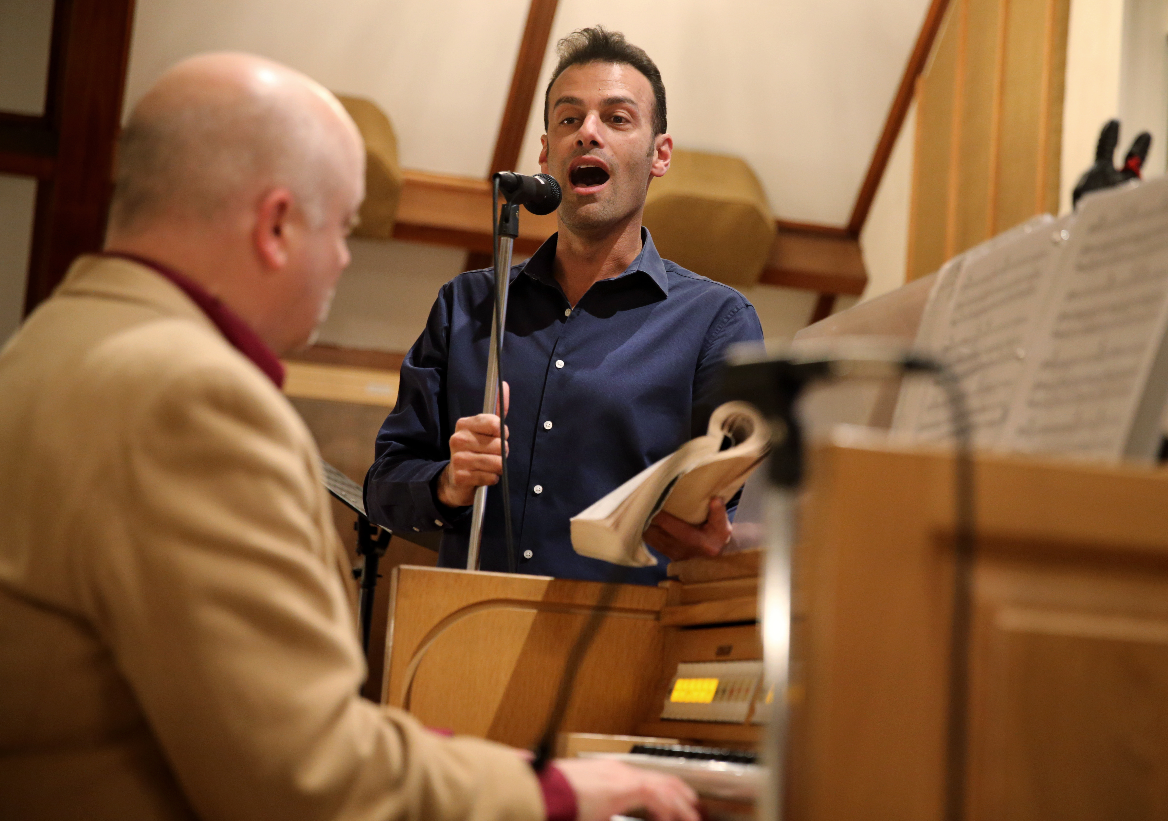 Andrew Giordano sings during a service at St. Barbara Parish Church accompanied by Todd Theriault, principal musician at the church.