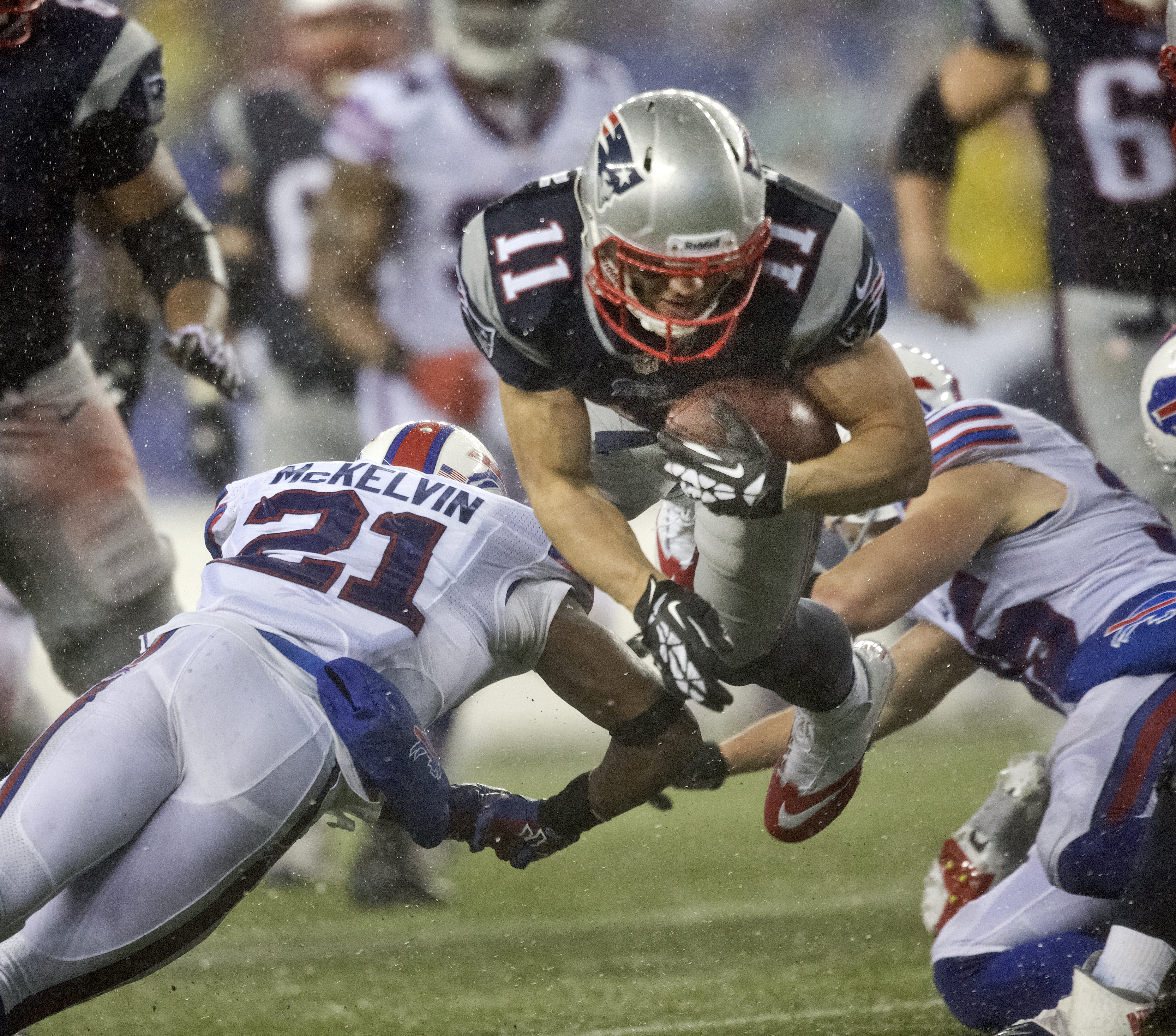 New England Patriots Julian Edelman got airborne as he was sandwiched by Buffalo Bills Leodis McKelvin (left) and Jim Leonhard after a 7-yard reception on Sunday.