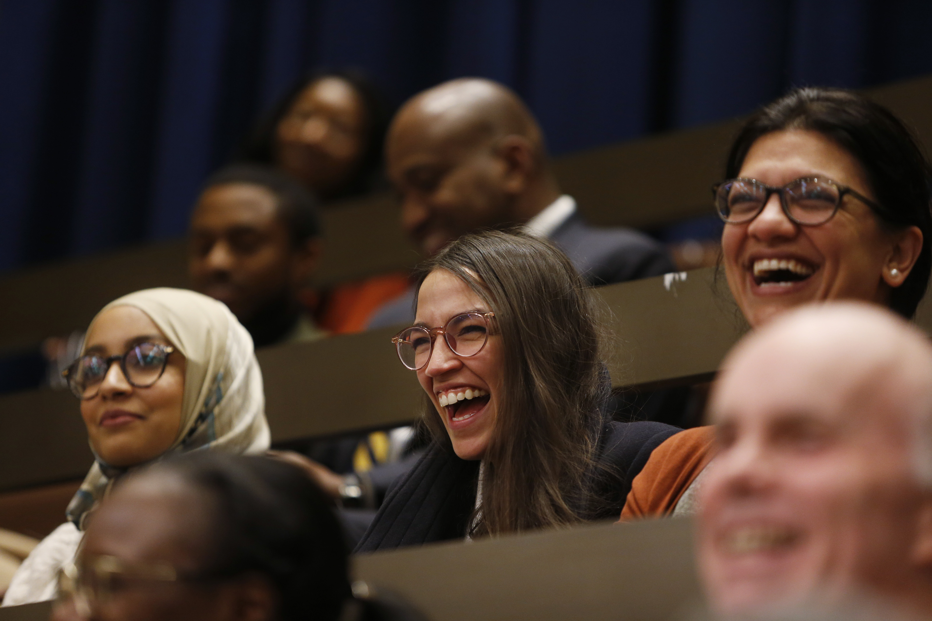 Fellow congresswomen-elect Alexandria Ocasio-Cortez, center, and Rashida Tlaib, right, laughed as city councilors referenced them in their farewell speech to Ayanna Pressley at City Hall.