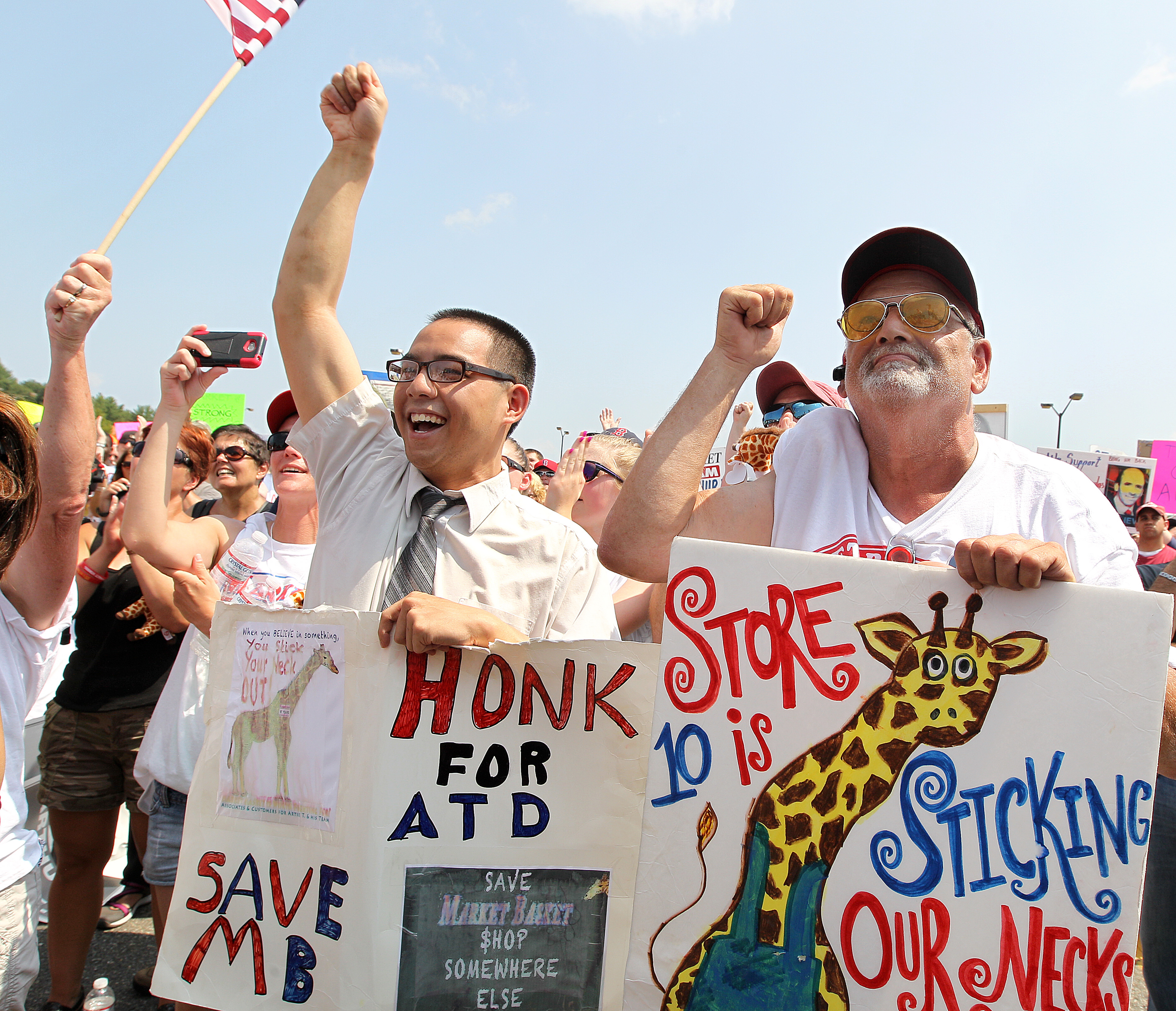 Kevin Wong, a bagger in Tewksbury, and John Connor, a customer, attended a rally Tuesday.