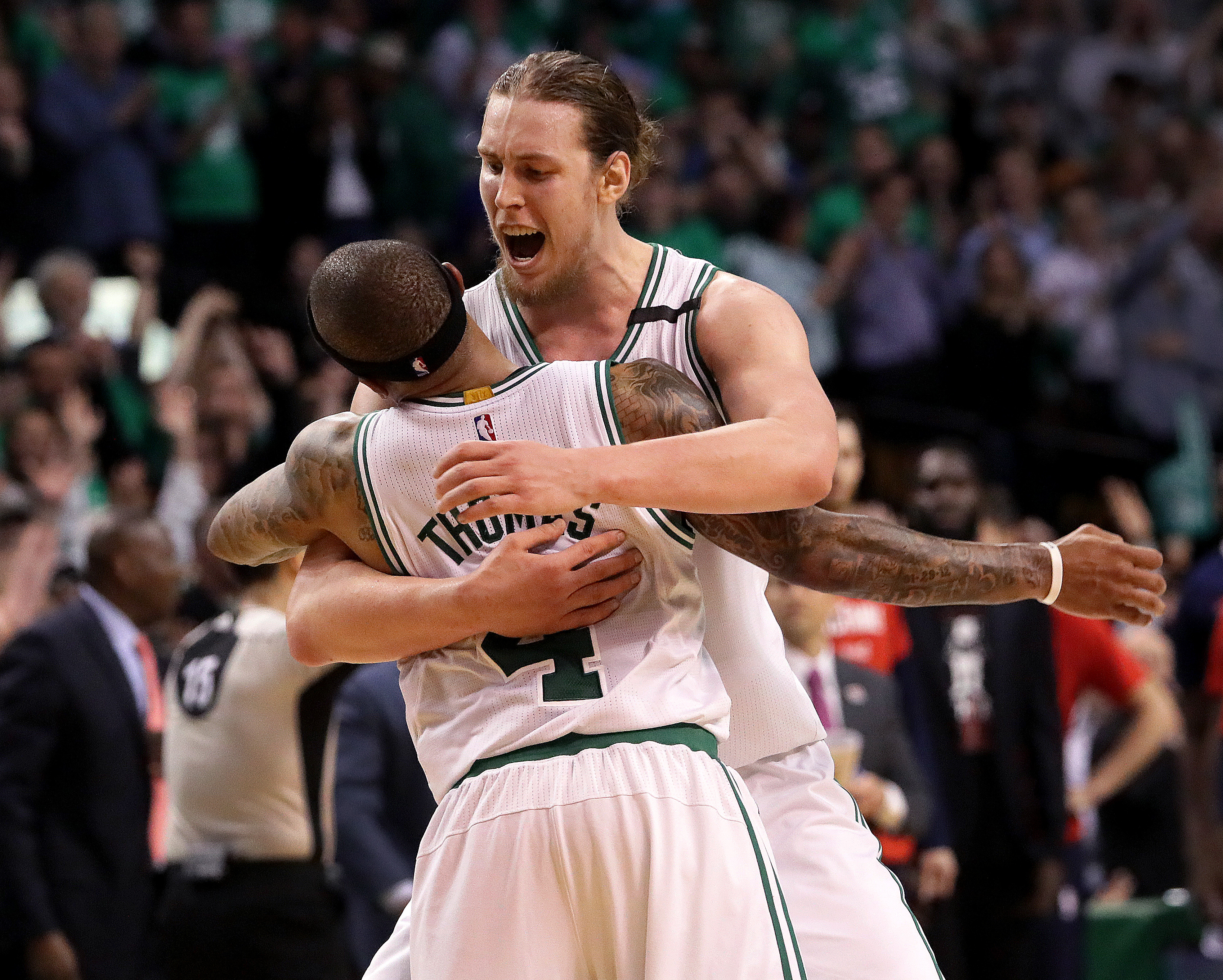 Isaiah Thomas (29 points) and Kelly Olynyk (26) embrace during the Celtics’ game-breaking run.