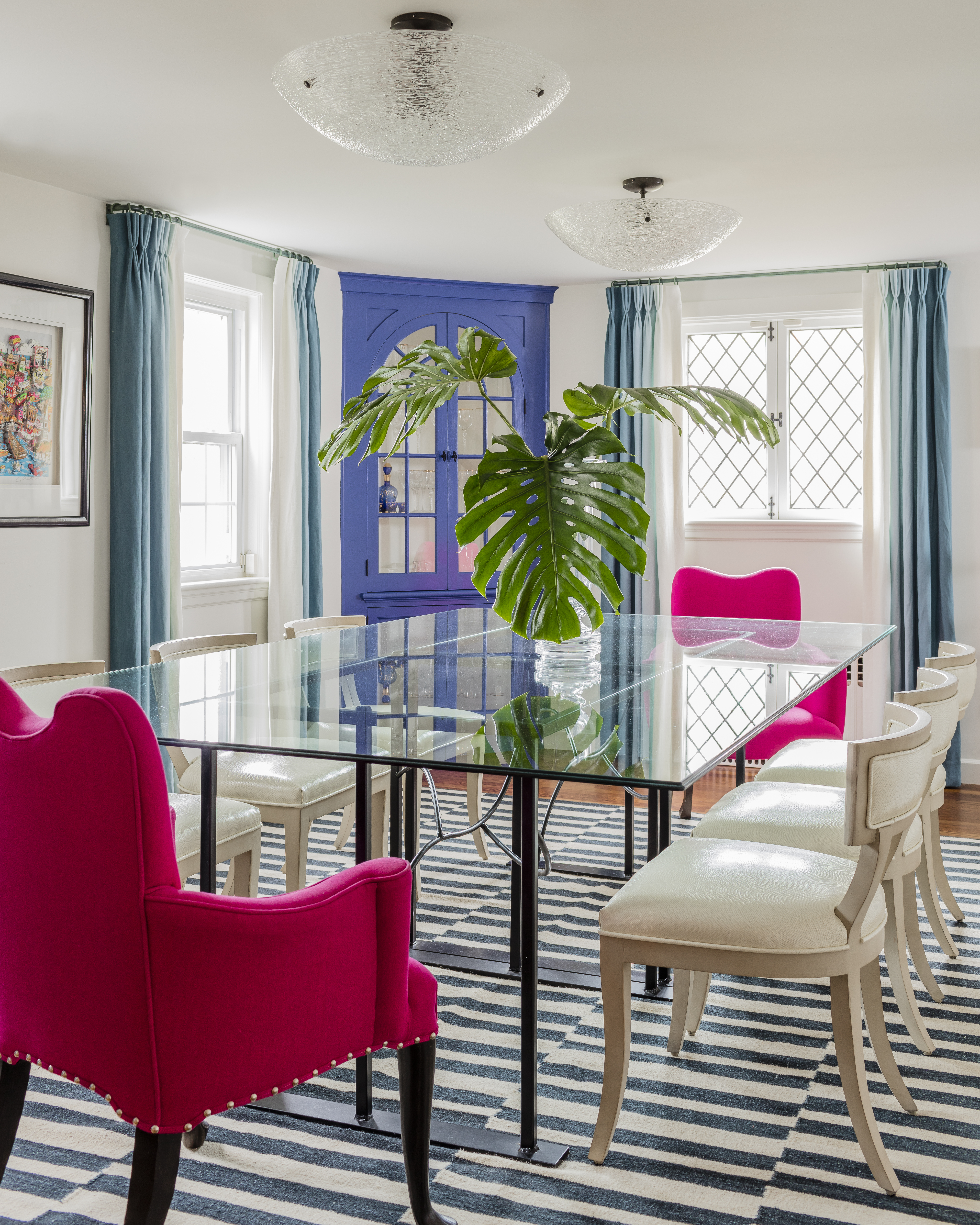In the dining room, new pink linen host chairs and Zentique curved-back side chairs surround the existing table.