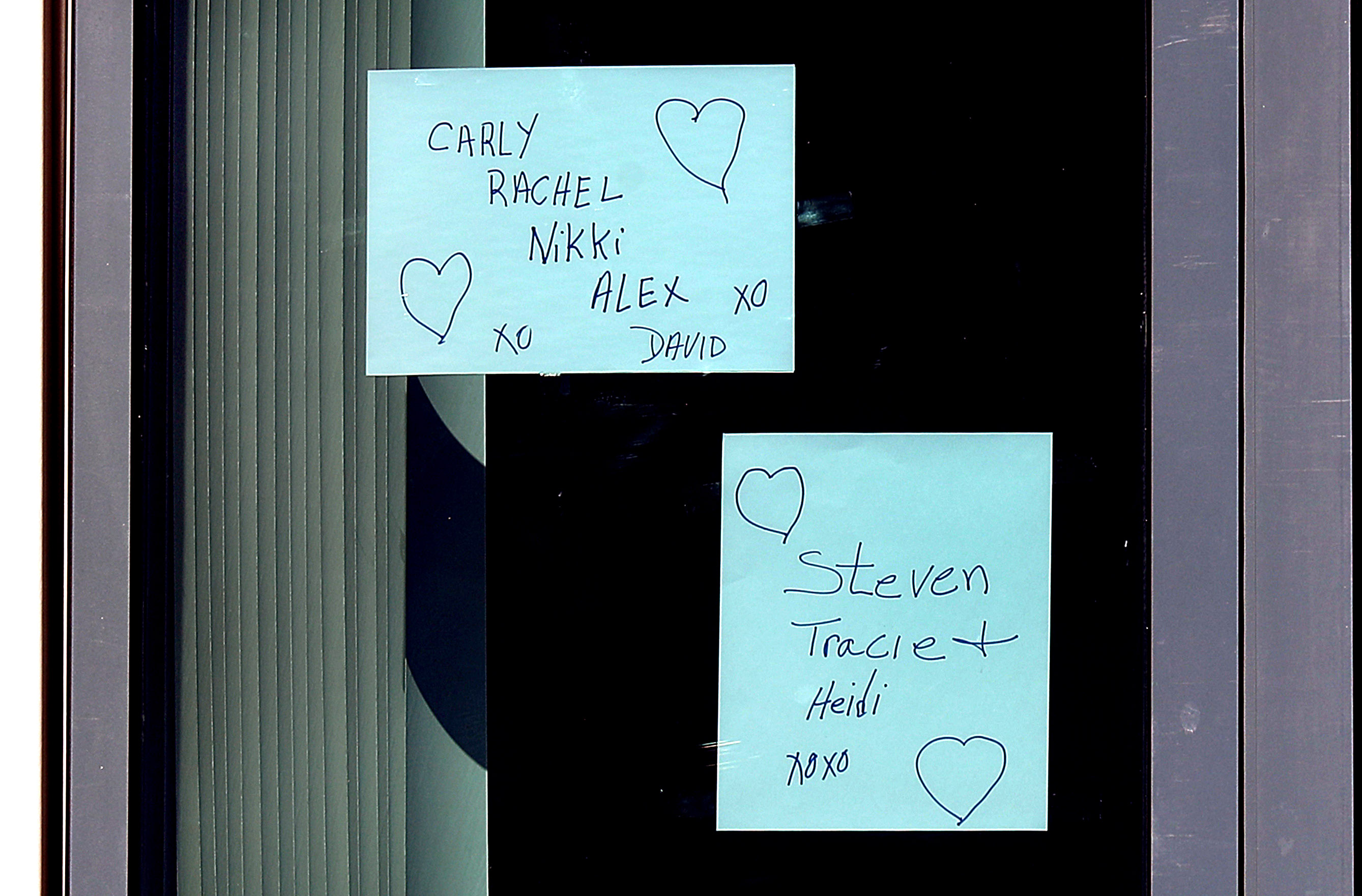Messages taped to an upper floor window at the Jack Satter House in Revere, which has the largest known outbreak at senior facilities statewide.