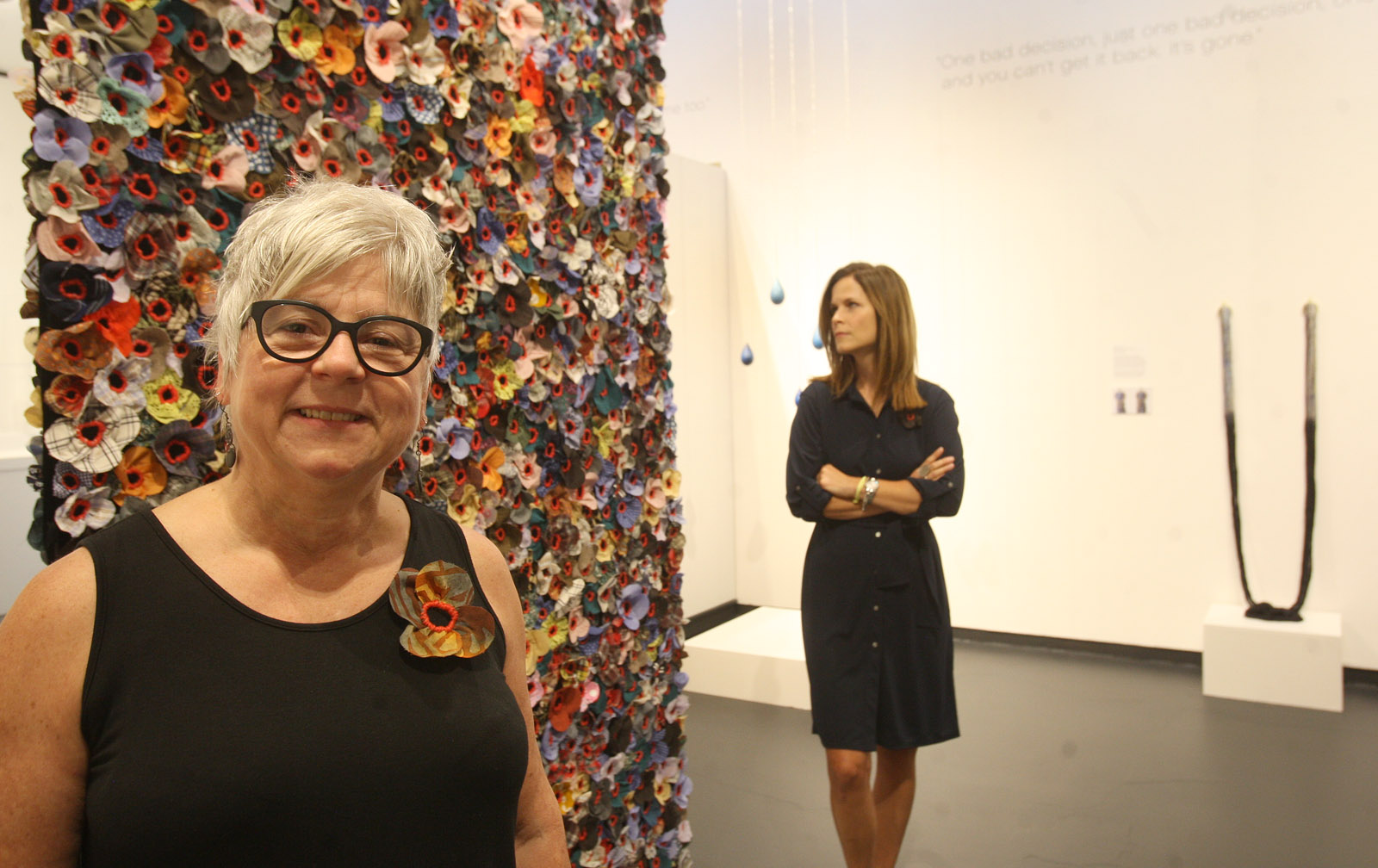 Sculptor Jodi Colella of Somerville is one of the artists participating in the exhibit, which was curated by Beth McLaughlin (background). McLaughlin said museums are trying to do more shows that have social impact.