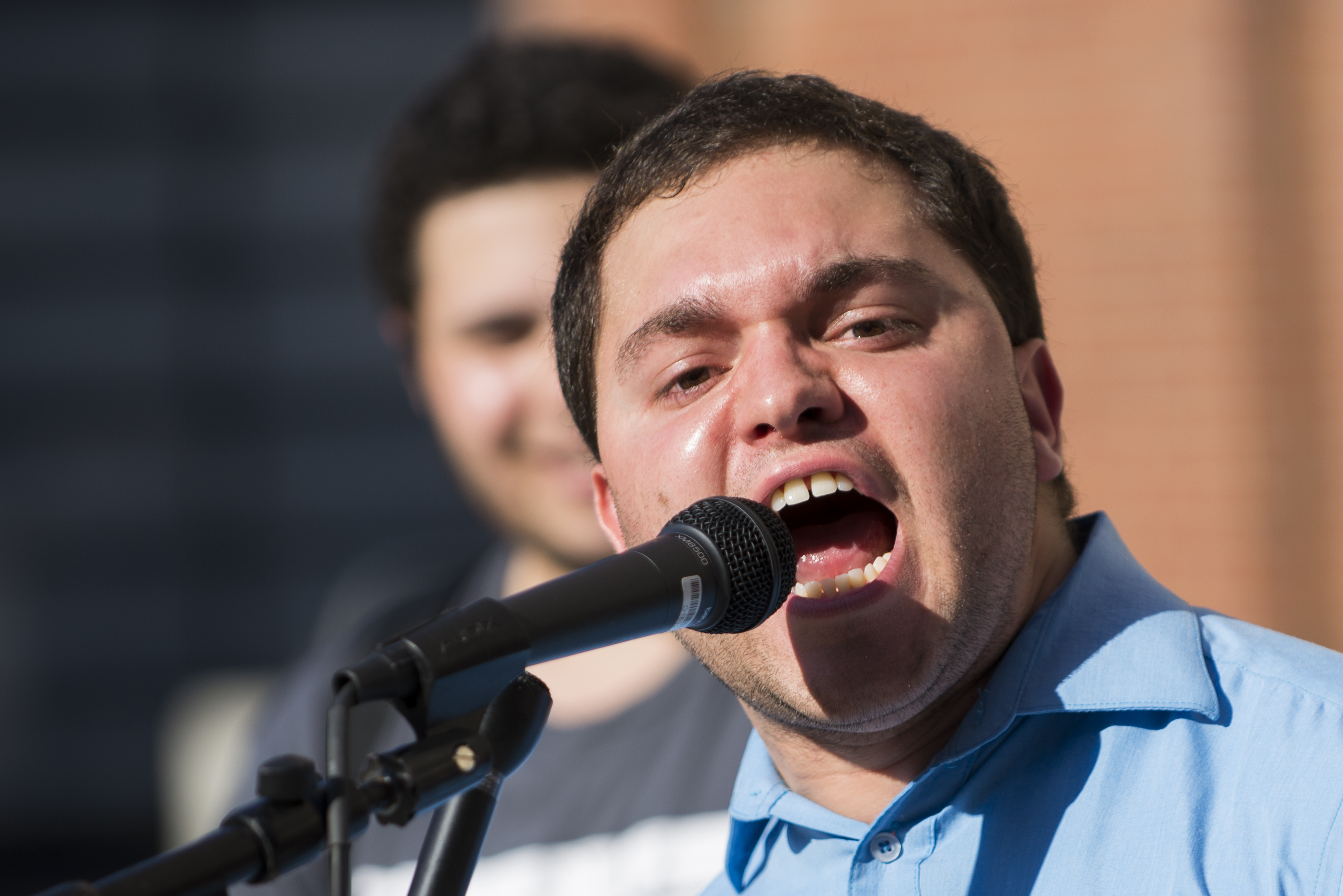 Filipe Zamborlini, a green card holder and undocumented immigrant advocate riles up the crowd.