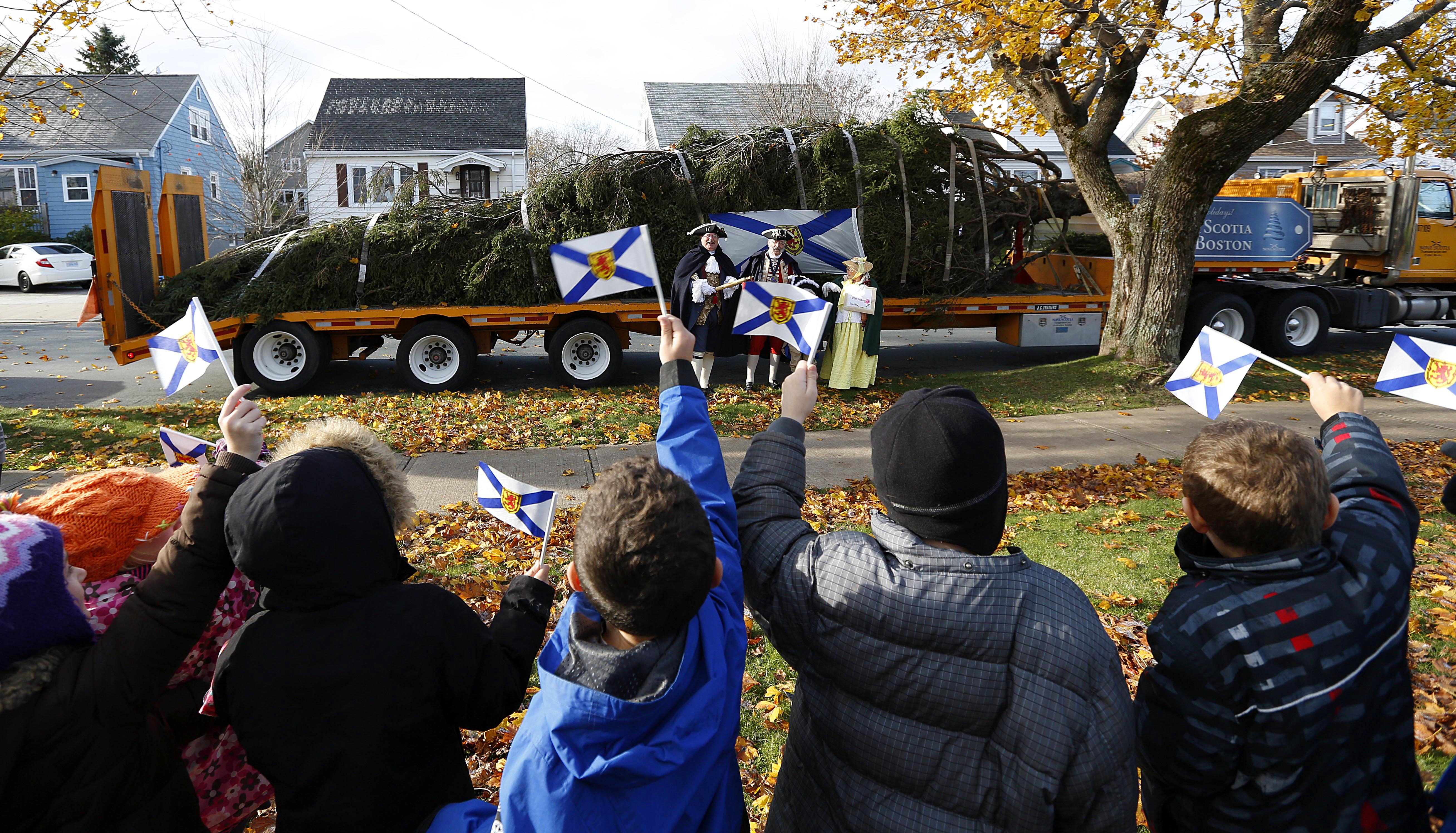 Students from St. Stephen’s Elementary School in Halifax, Nova Scotia, were on hand as a Christmas tree passed by on its way to Boston.