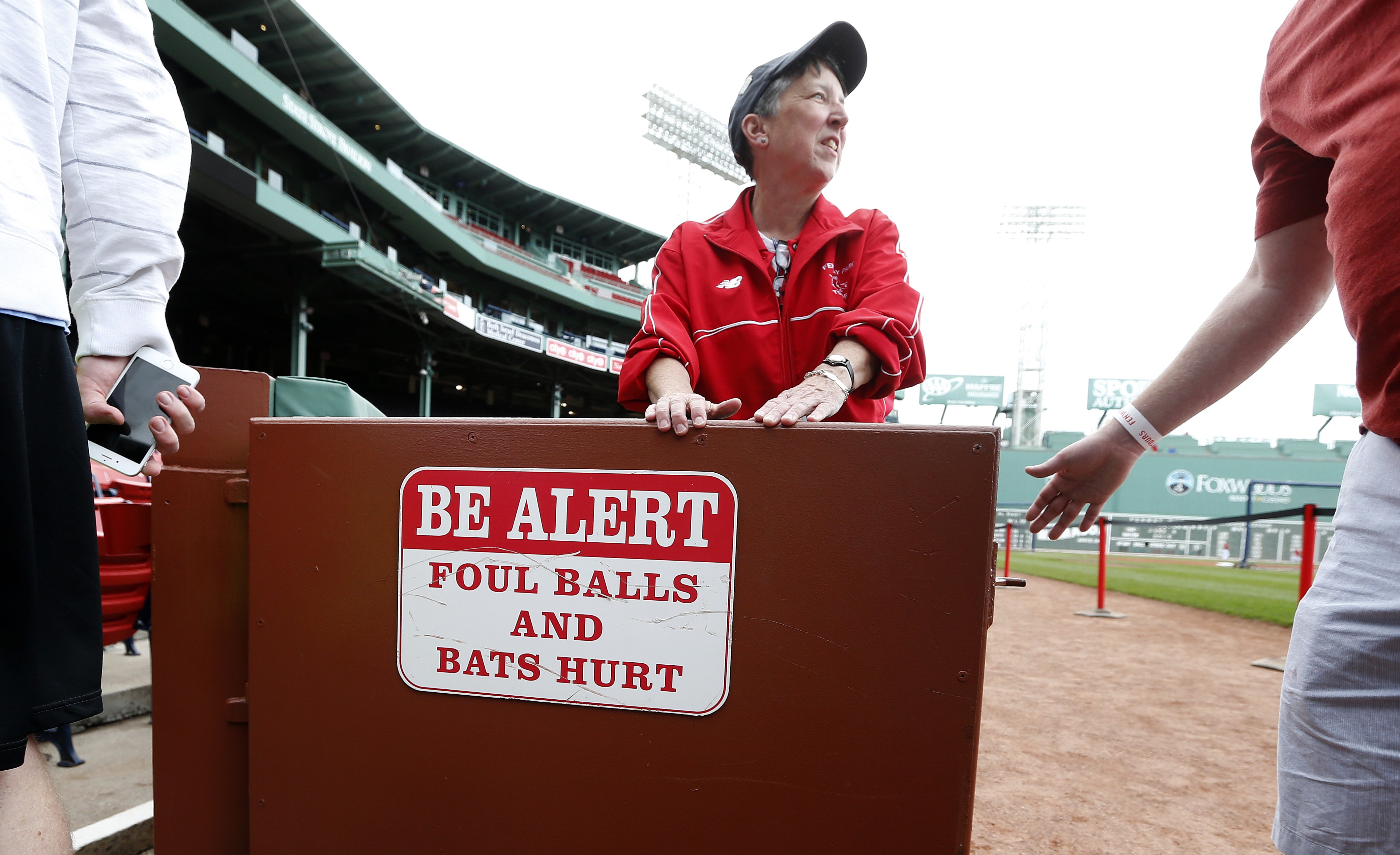 Signs at Fenway Park warn of foul balls and errant bats.