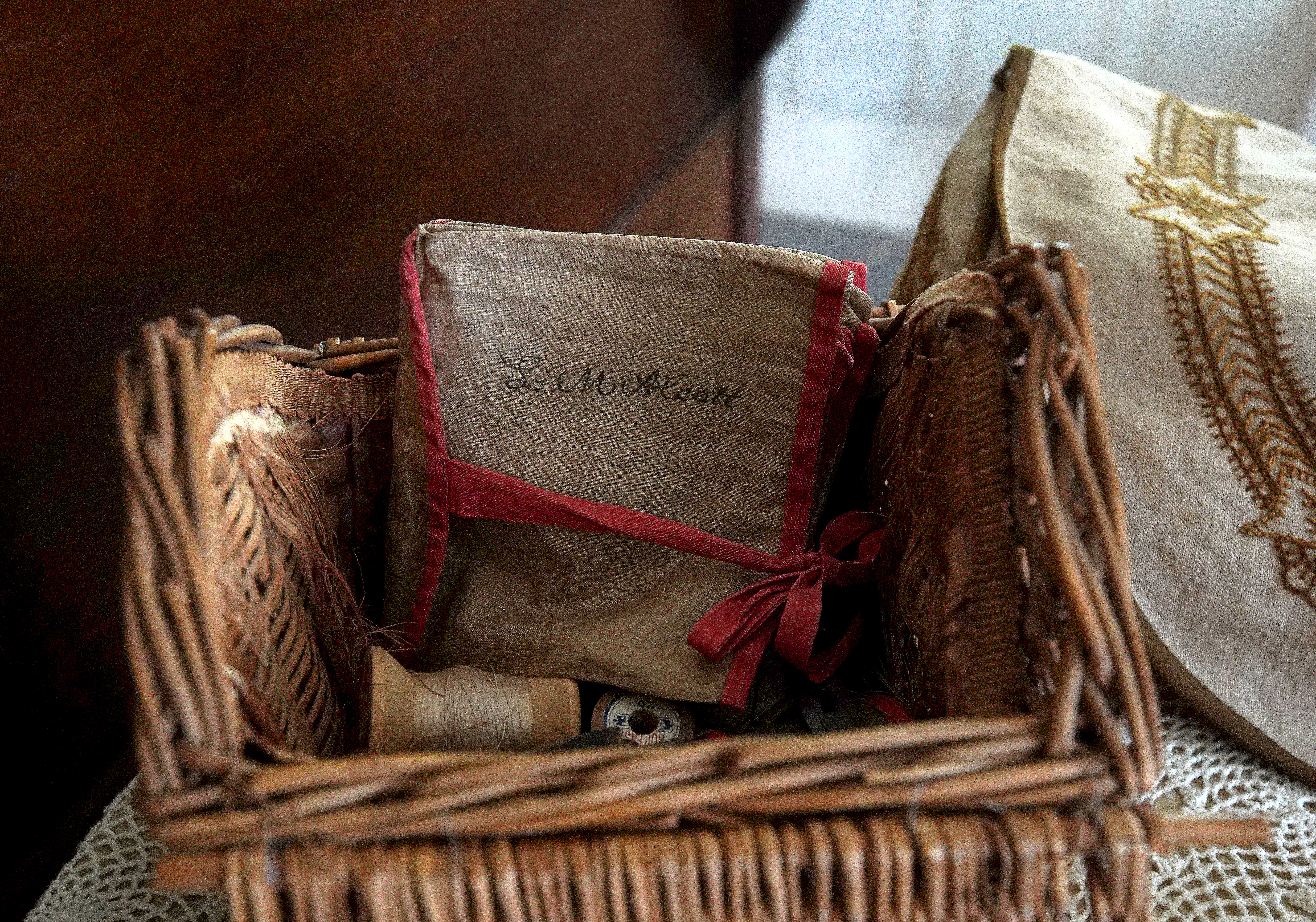 Louisa's handwritten name is on sewing kit materials on display at Orchard House.