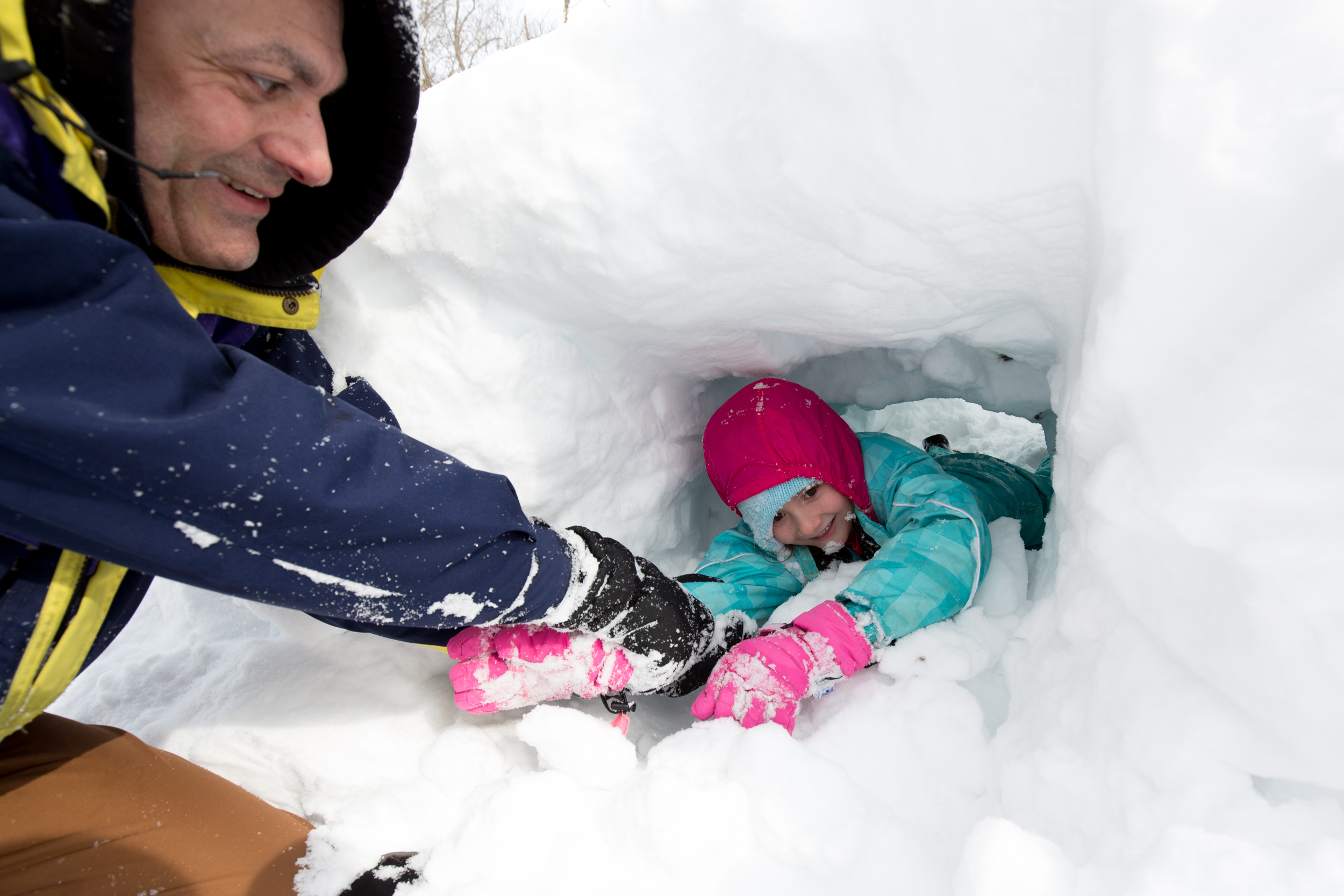 Adam Barbosa, left, pulled Bridget Barbosa, right, from a snow shelter during a mountaineering skills program.
