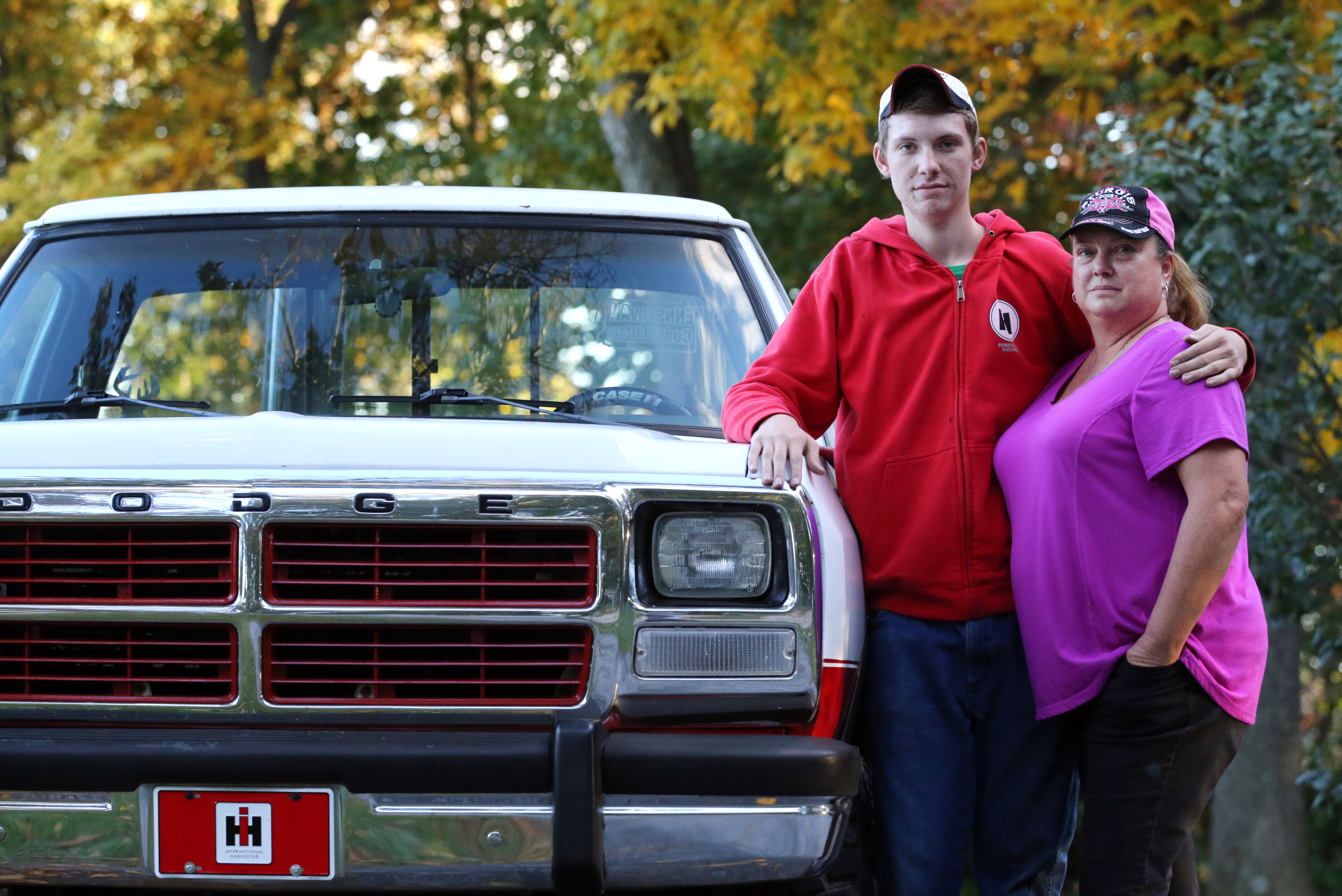 Dalton Lesley, 17, a junior at York County School of Technology, and his mother, Sue, next to the 1991 Dodge pickup he rebuilt, at their home in New Freedom, Pa.