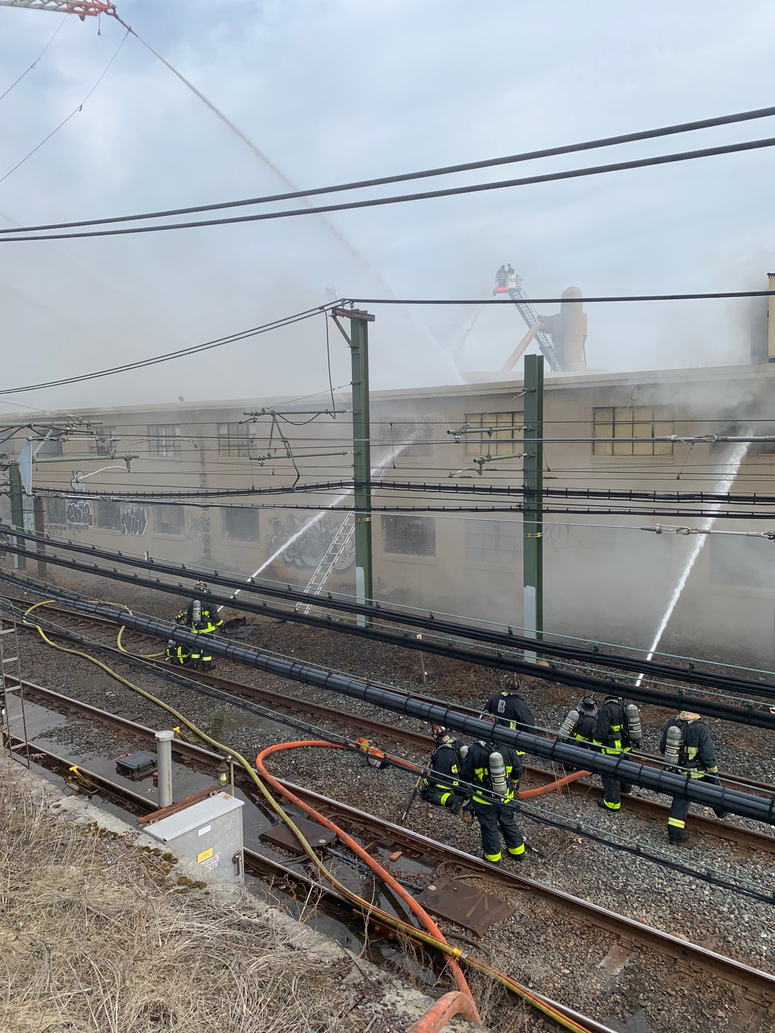 Fire crews took to the Blue Line tracks to pour water on the building.