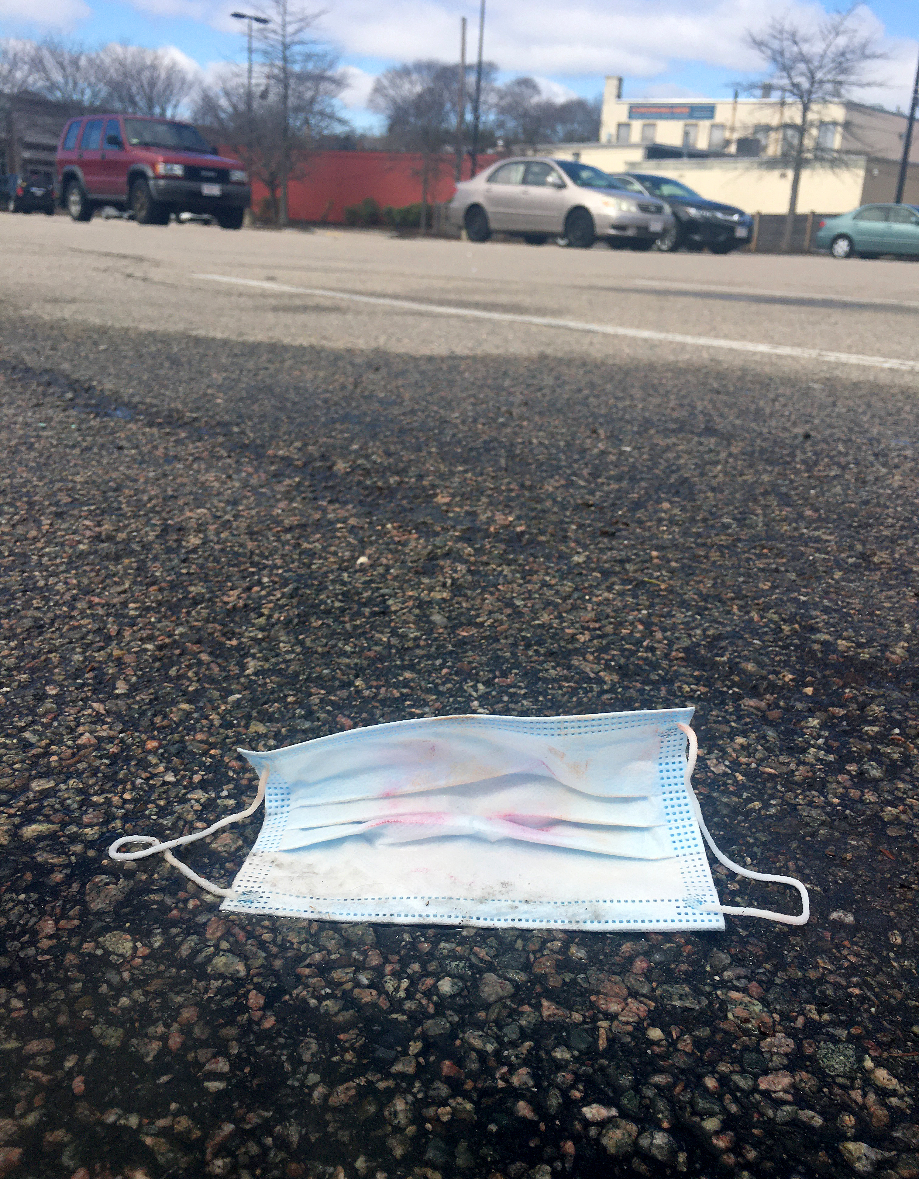 A discarded mask laid in the parking lot of the Roche Bros in West Roxbury