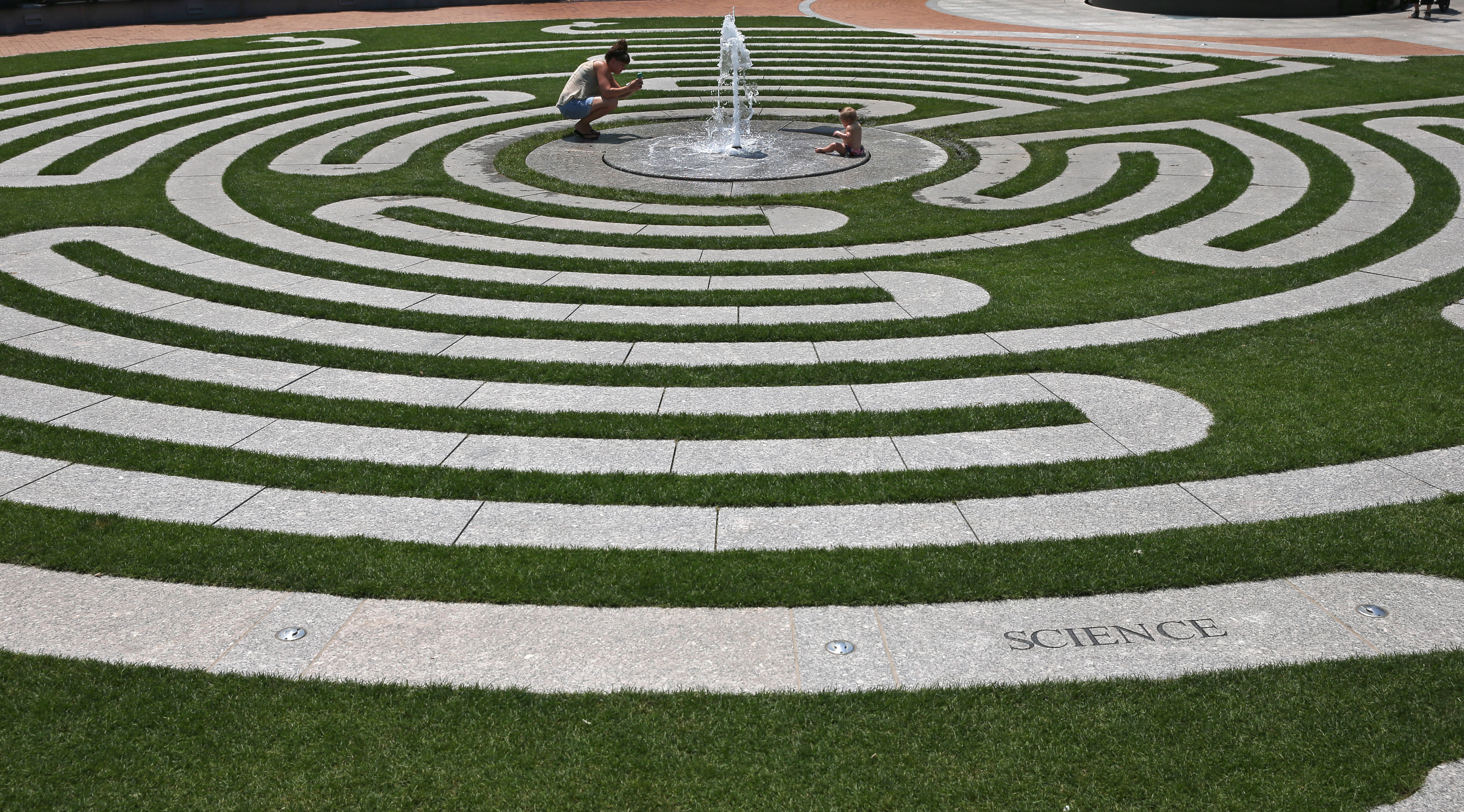 Adrienne Hernandez took a photograph of her 10-month-old daughter Grae Magnolia Hernandez keeping cool by a fountain on the Labyrinth at Armenian Heritage Park on the Rose Kennedy Greenway.