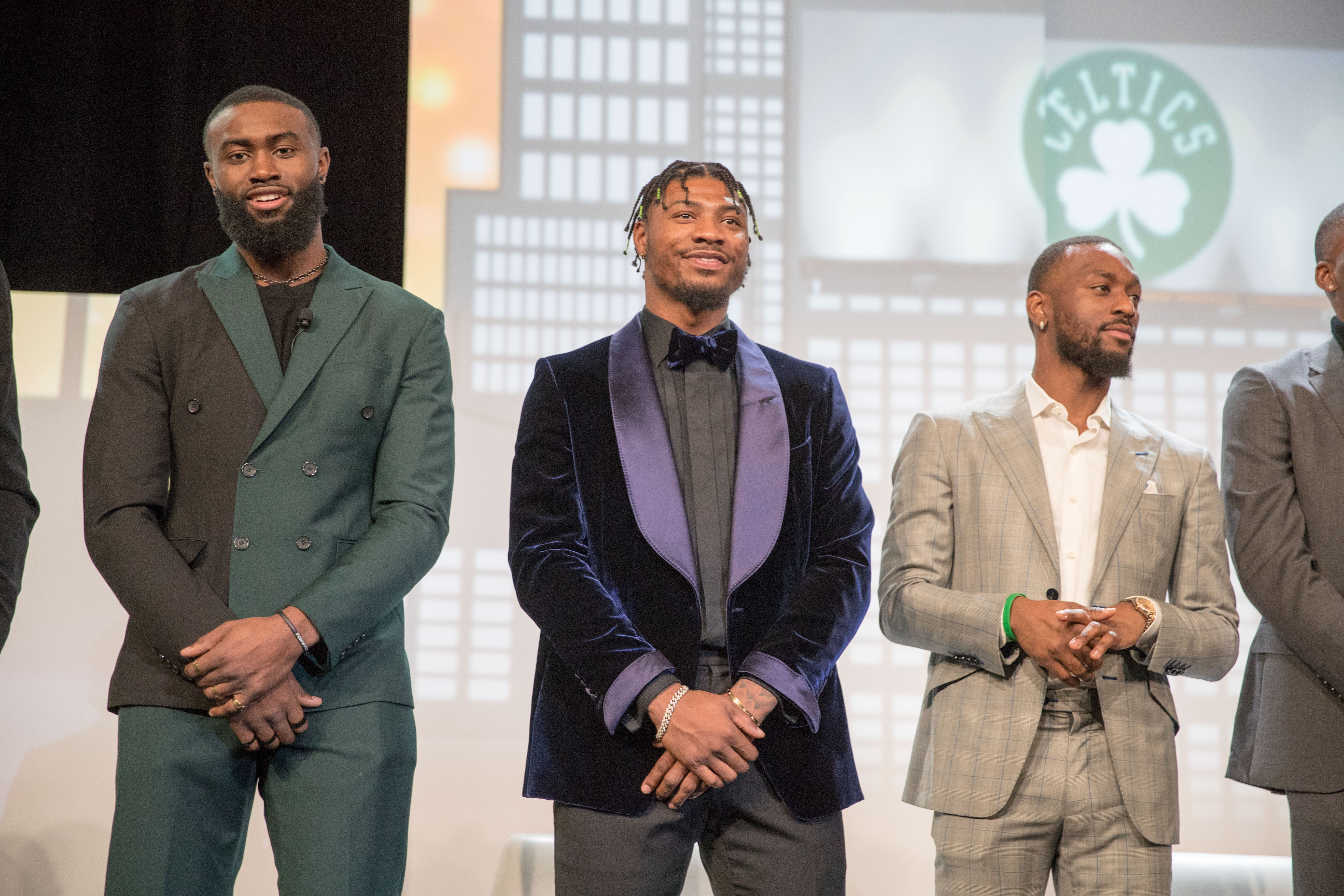 Boston Celtics (from left) Jaylen Brown, Marcus Smart, and Kemba Walker show off their suits on stage.