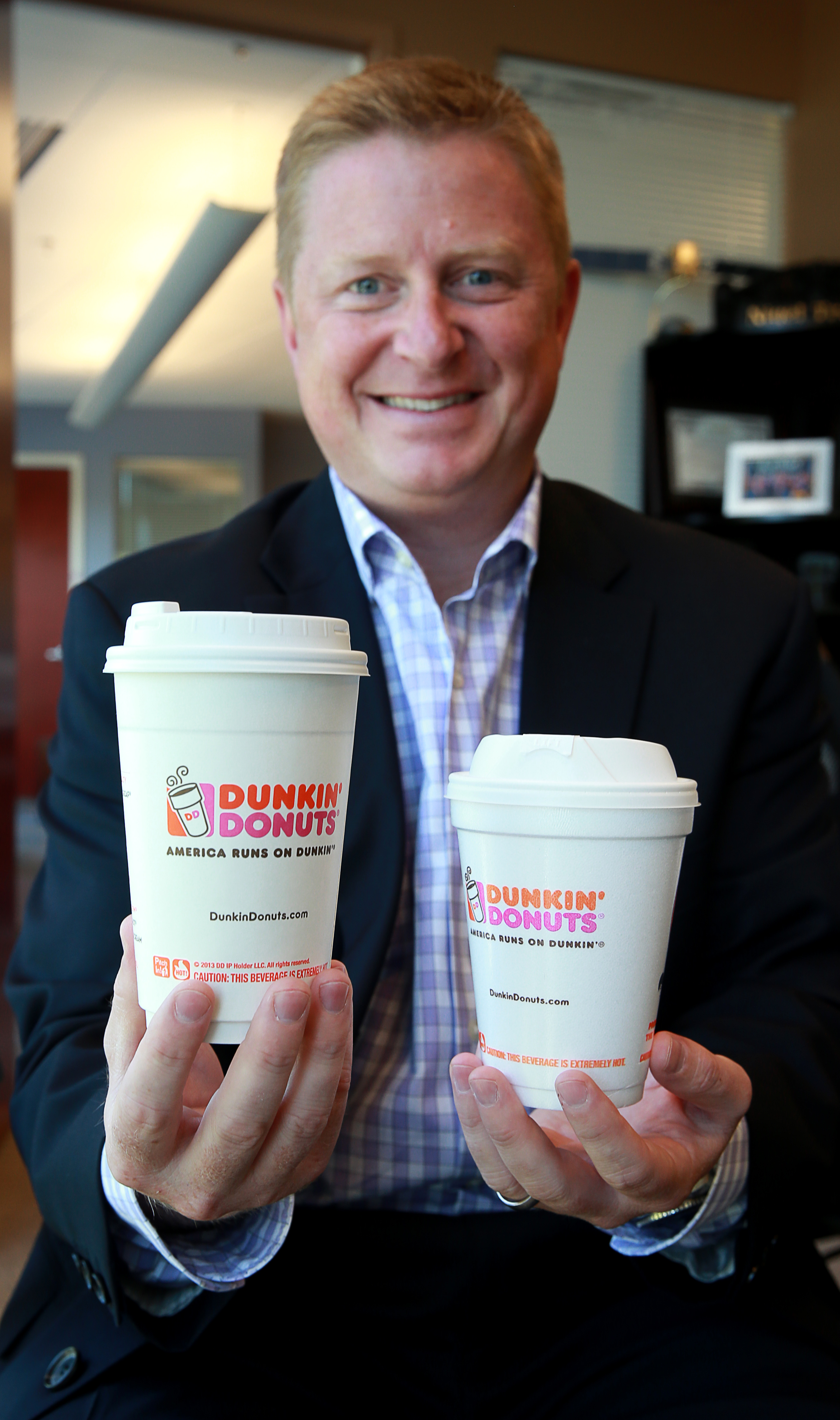 Scott Murphy of Dunkin’ Donuts with the new-style cups.