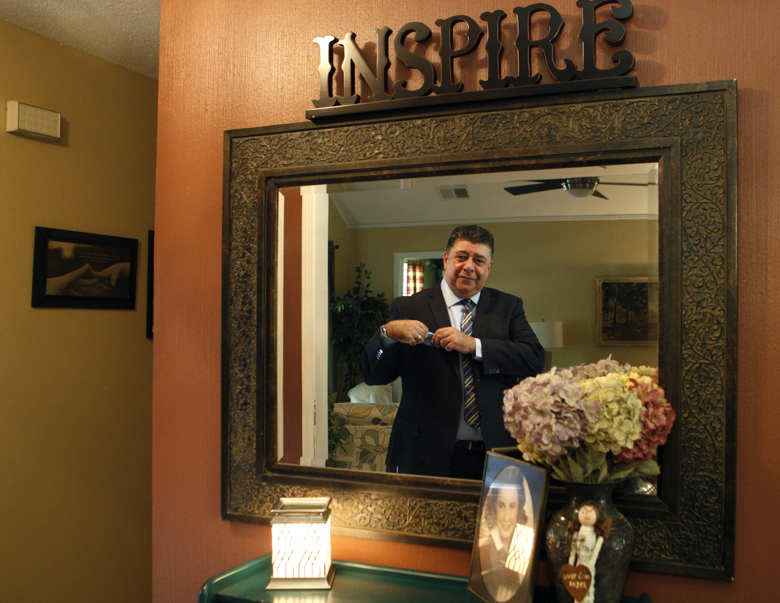 Esposito checked himself in a mirror before leaving for church.