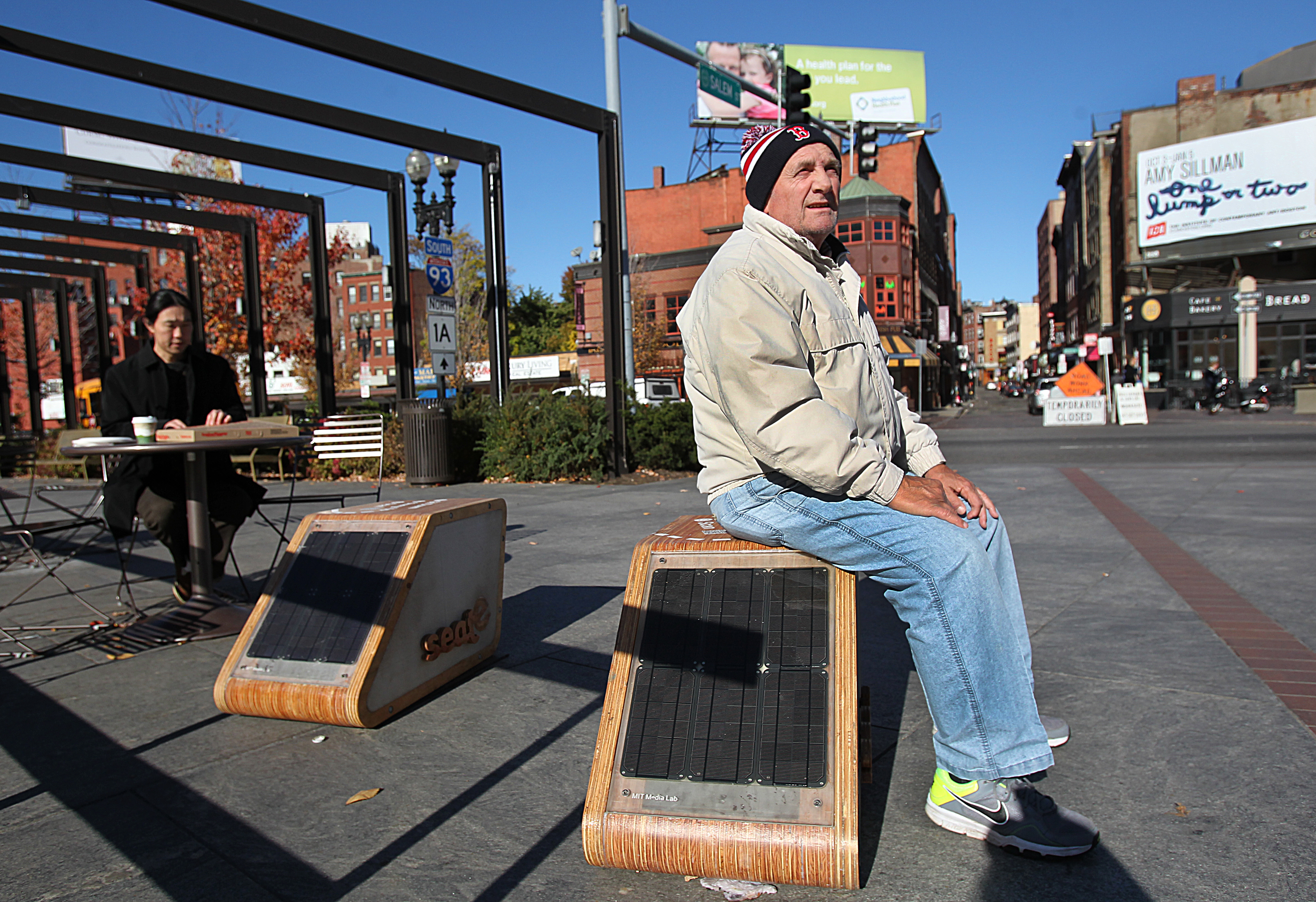 Boston, MA., 11/04/13, The city of Boston has installed two high-tech seats on the Rose Kennedy Greenway that can charge smartphone and sense how much a person weighs and whether they are smoking. The seats were invented by an MIT researcher. We are going to the Greenway to see what people in Boston think about these high tech smart seats. Rocco Rossi, cq, was born and raised in the North End, and does not own a cell phone. When passing by the seats he was quizzed by a reporter about them. He said: "They look like homemade jobs." and then he offered to sit down on it. Suzanne Kreiter/Globe staff