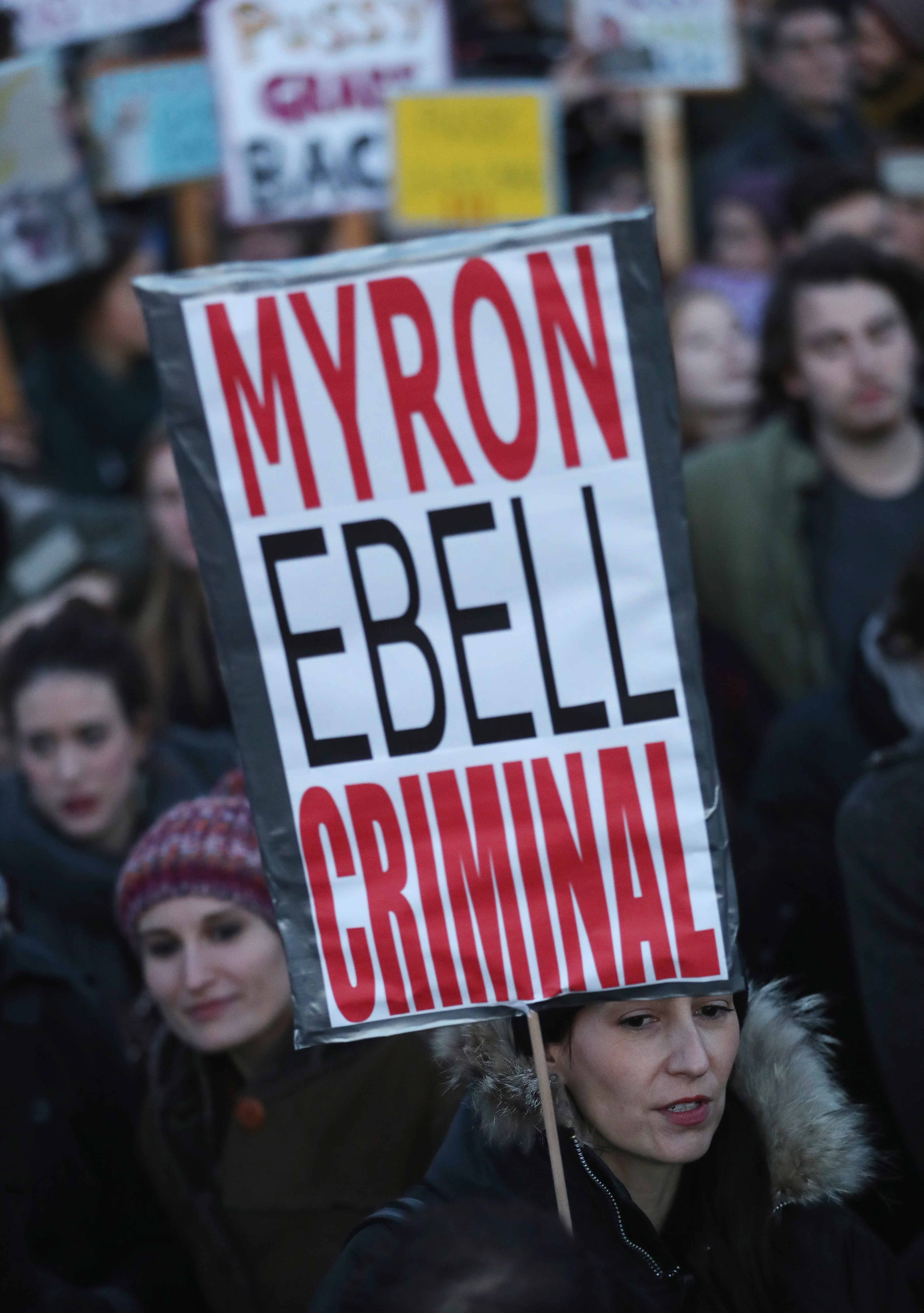Protesters critical of Donald Trump, including one holding a sign labeling Trump climate policy advisor and global warming skeptic Myron Ebell as a criminal, gather for a demonstration near the Brandenburg Gate in Berlin on Nov. 12.
