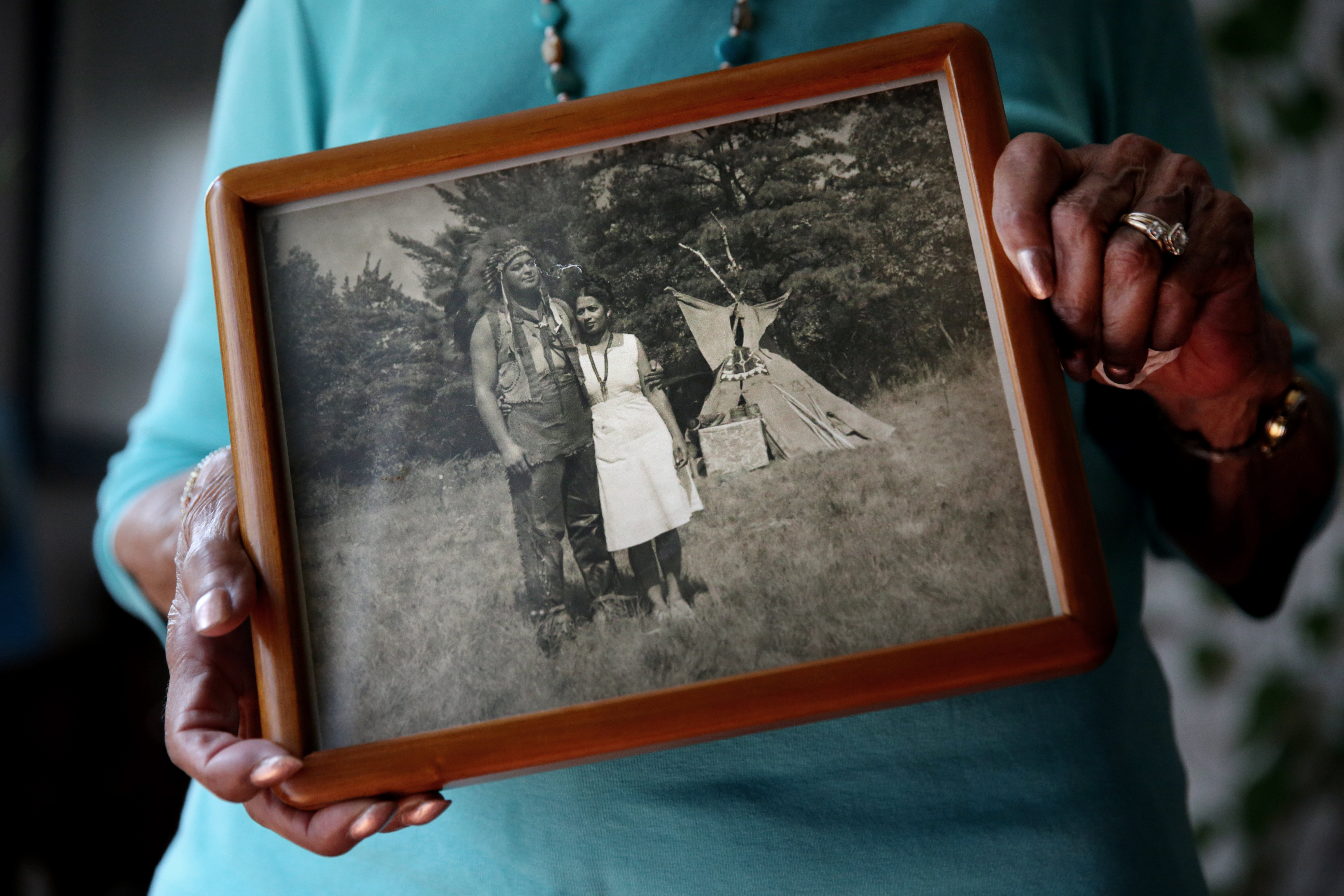 Eleanor Dove held a photograph of herself and her husband Ferris Dove at a Narragansett powwow around 1946.