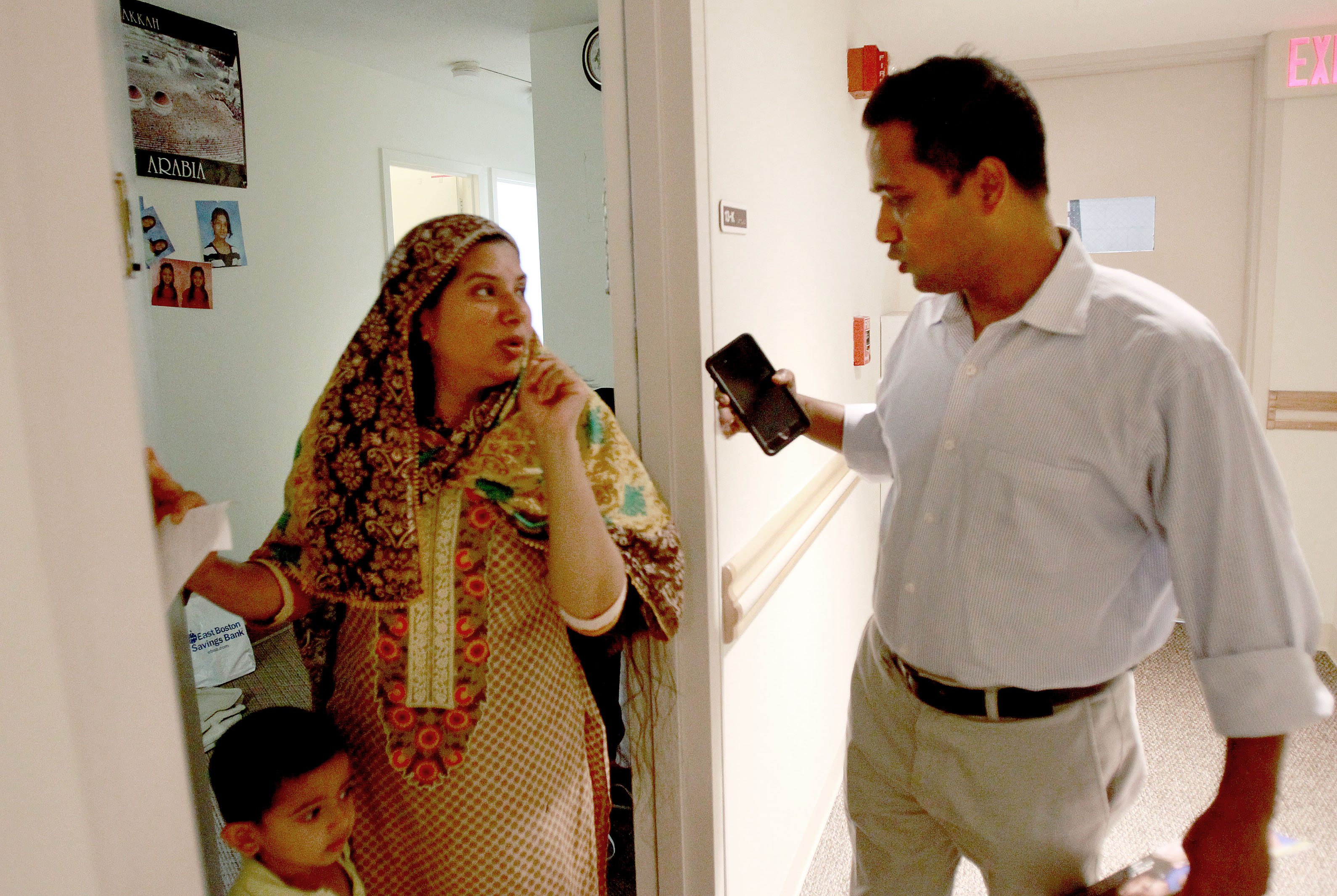 Resident Ruma Akter (left) spoke with community organizer Humayun Morshed during a canvassing effort in Cambridge.