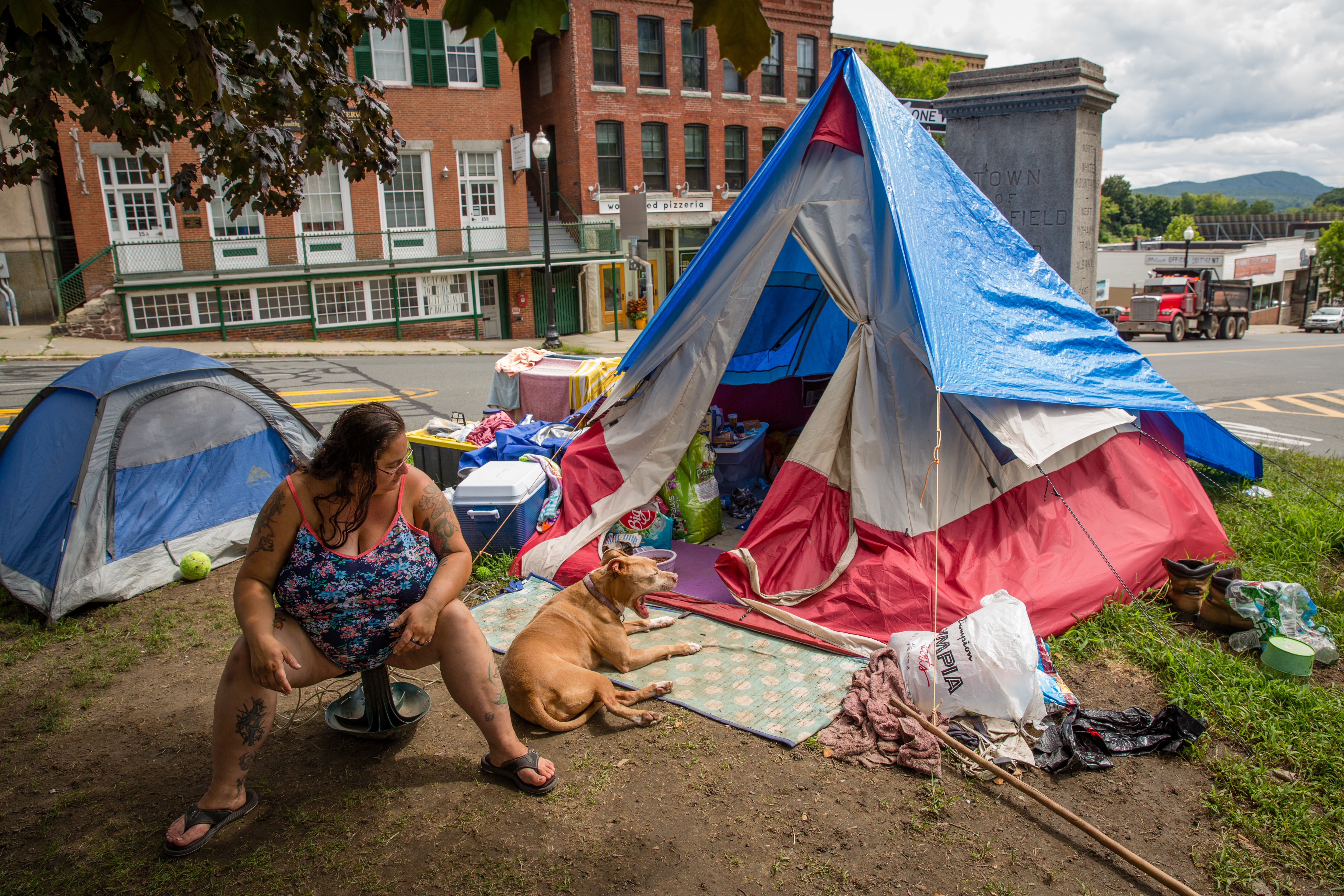 Madelynn Malloy sat on Greenfield's town common, which has been partially taken over by the tents of homeless people including Malloy.