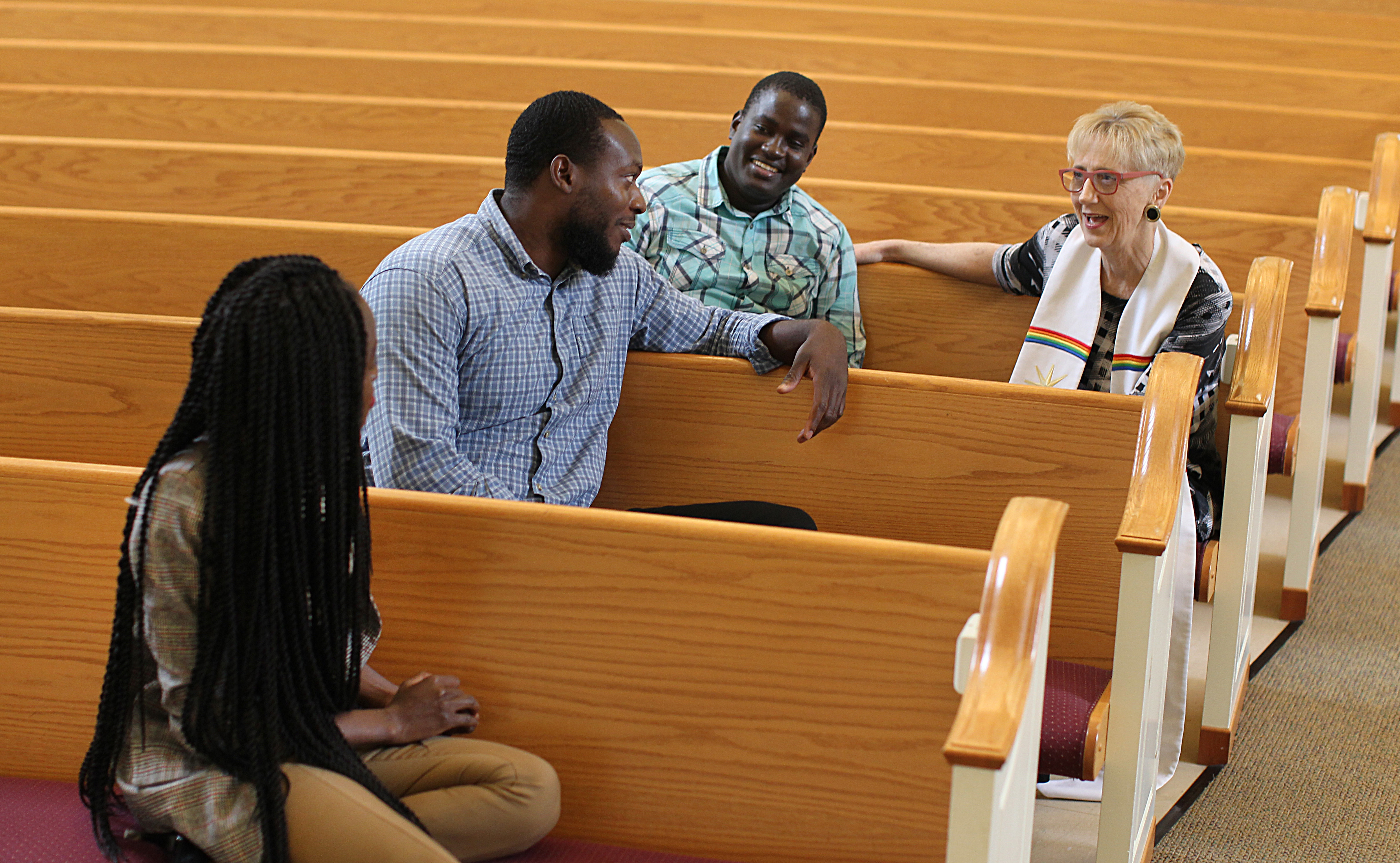 From left, Okumu; church deacon Al Green; Farouk Kaweesi, also from Uganda; and Judith Hanlon, pastor of Hadwen Park Congregational Church.