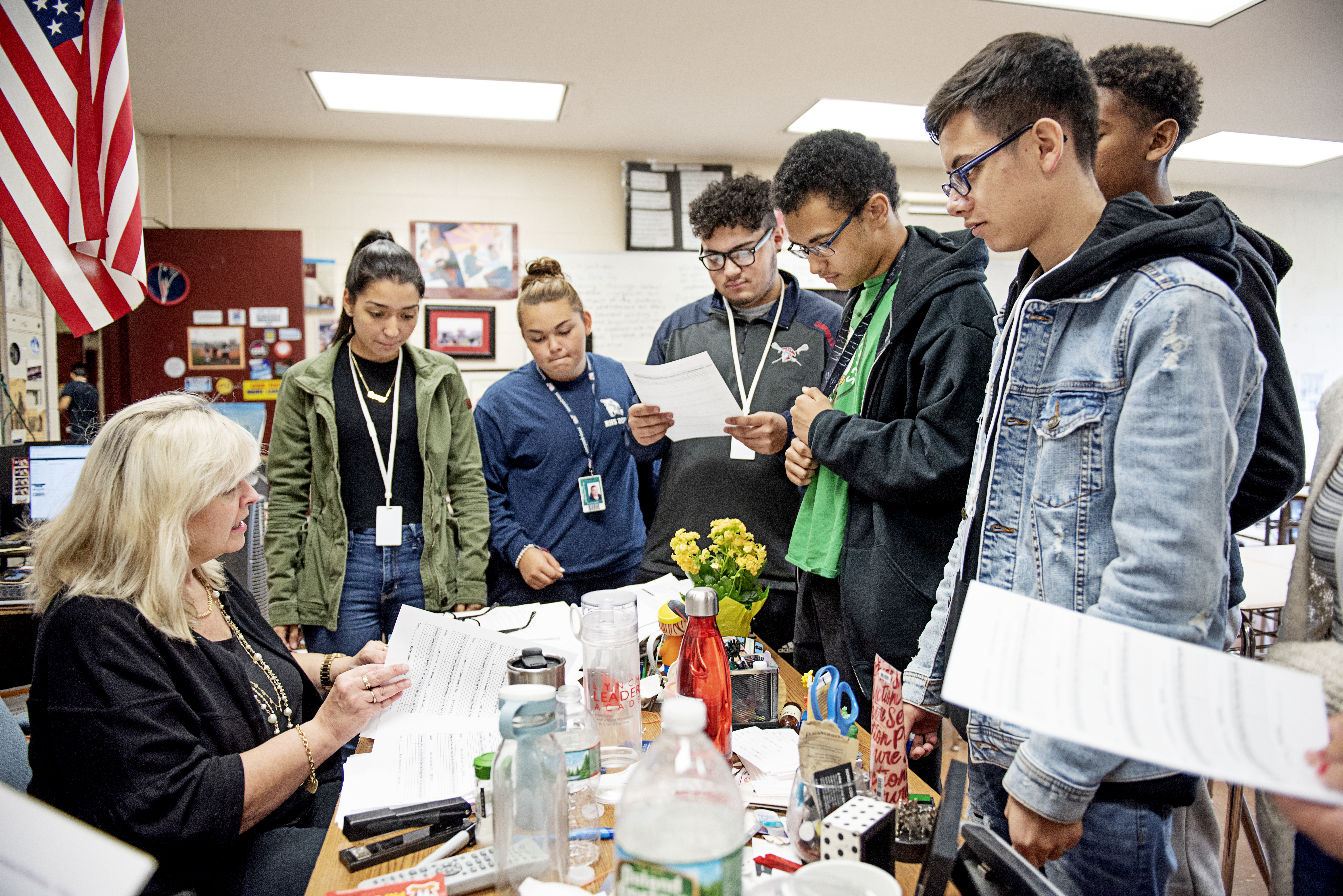 Nancy Barile, a veteran English teacher at Revere High School, talks with students in her classroom.