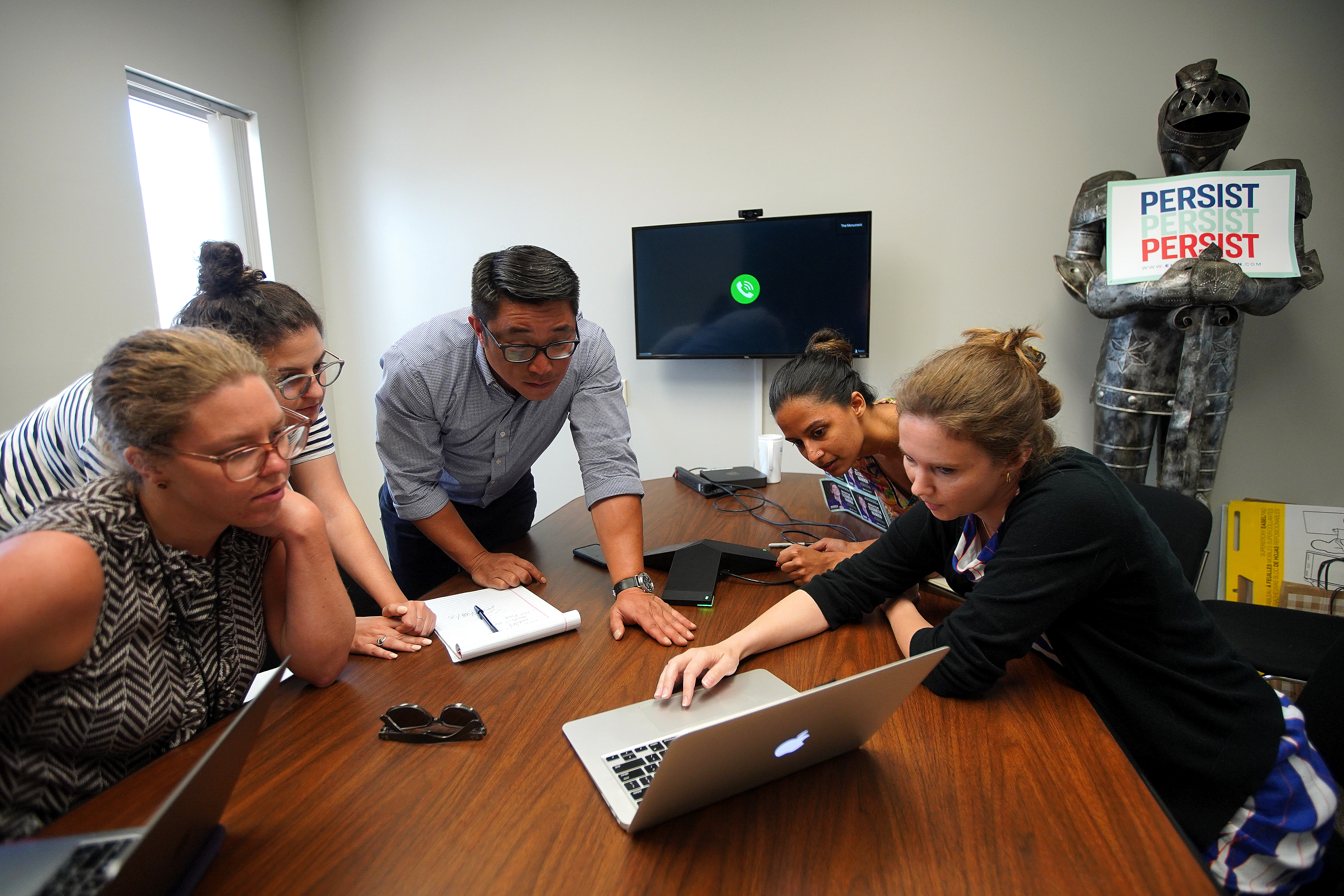 Campaign manager Roger Lau met with staffers during a meeting.
