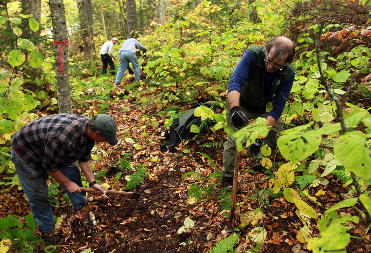 Kim Nilsen (right) and Yvan Guay worked with a team last month cutting the last two-fifths of a mile of the Cohos Trail.