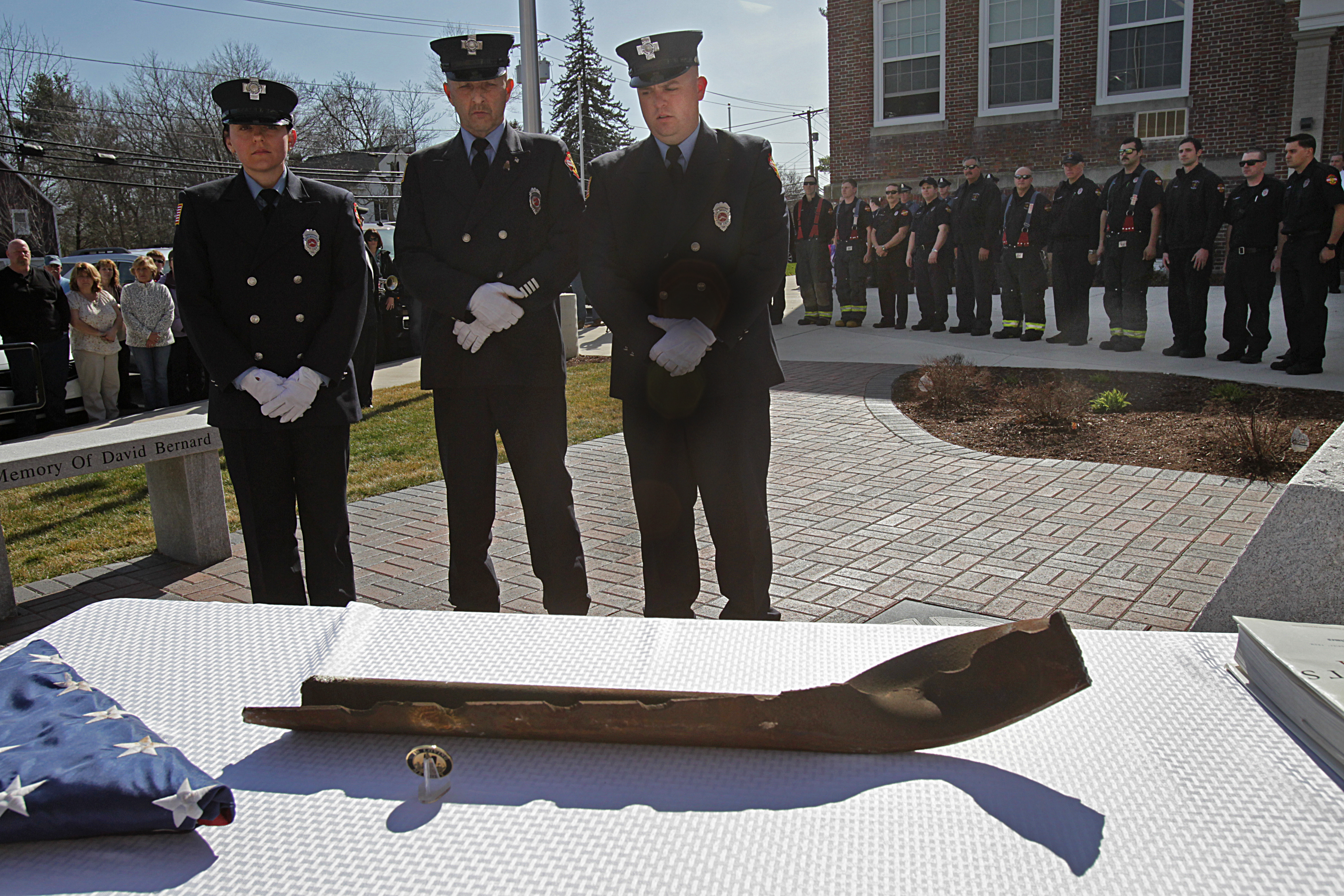 From left, Chelmsford firefighters Michelle Sacco, Donnie Peterson, and Bill Bennett brought a 30-pound, 24-inch beam from the 2001 World Trade Center attacks to the Chelmsford Fire Department. In the days after the terrorist attacks, seven Chelmsford firefighters traveled to New York to assist in the recovery.