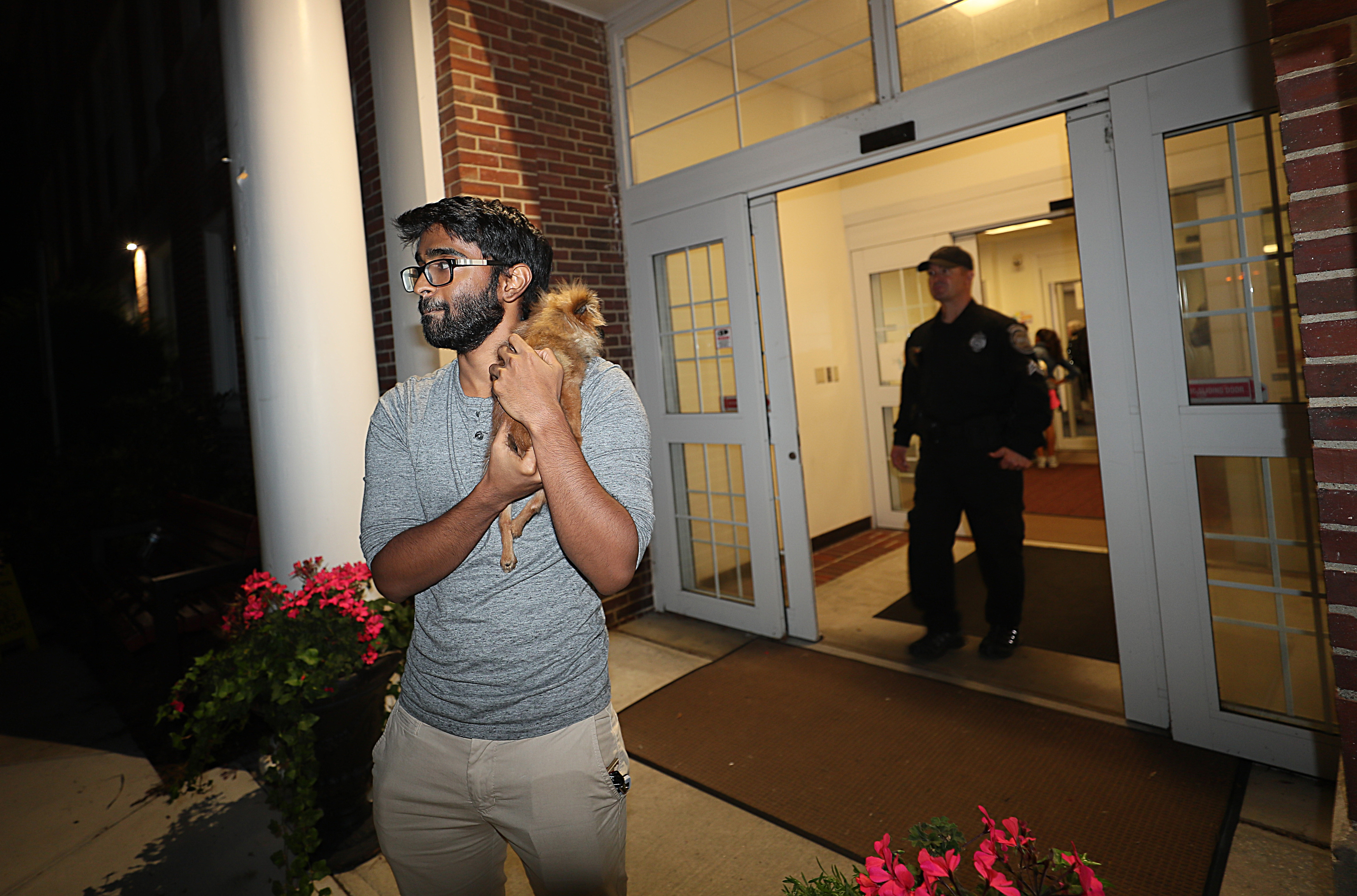 Shawn Daniel of Lawrence waited outside a shelter at the Andover senior center on Thursday. The shelter was not accepting pets, and he was hoping to be allowed back into his home.