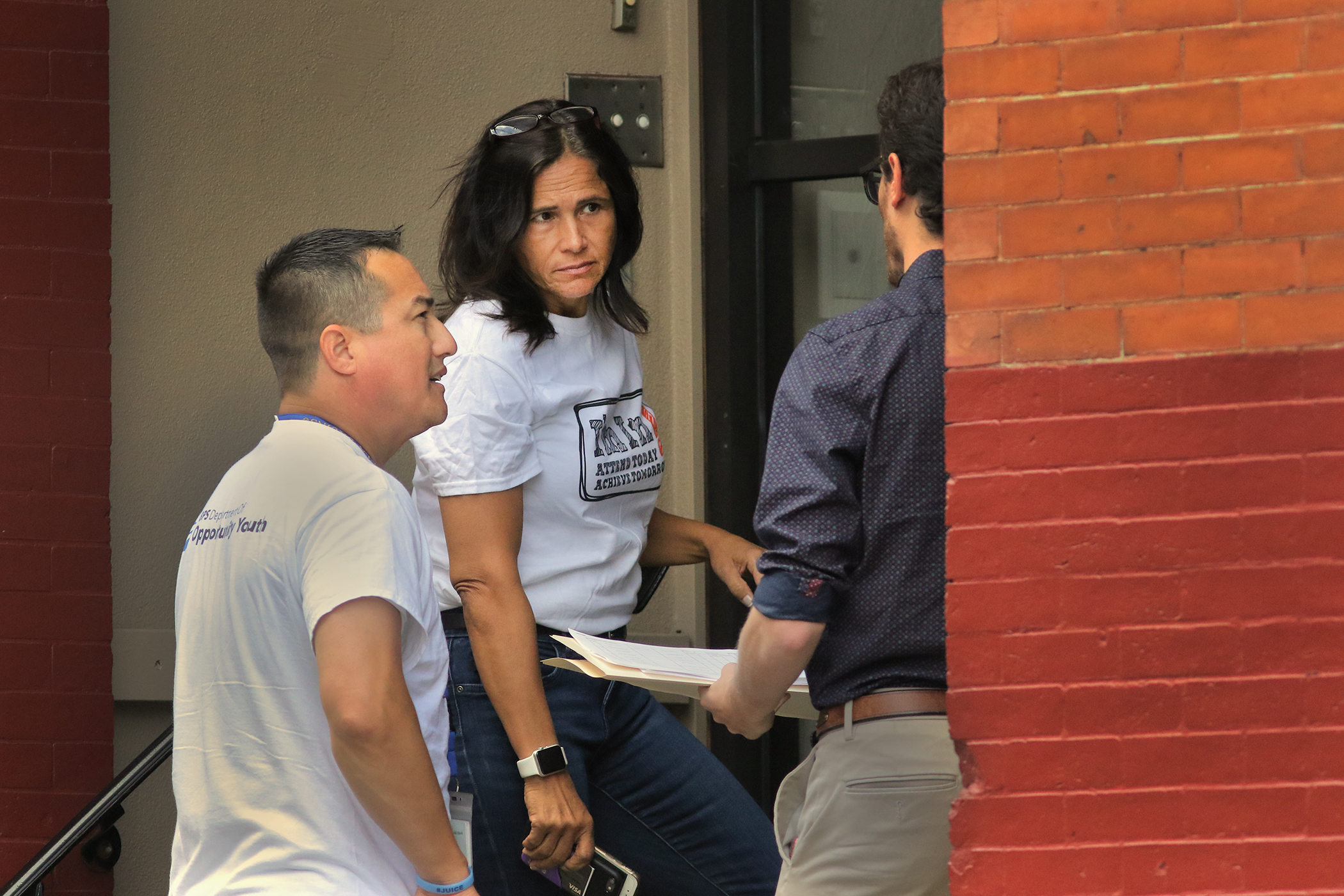 Superintendent Brenda Cassellius was joined outside a student’s home by Tommy Welch (left), a high school superintendent, and Bobby Brown, of the Boston Private Industry Council.