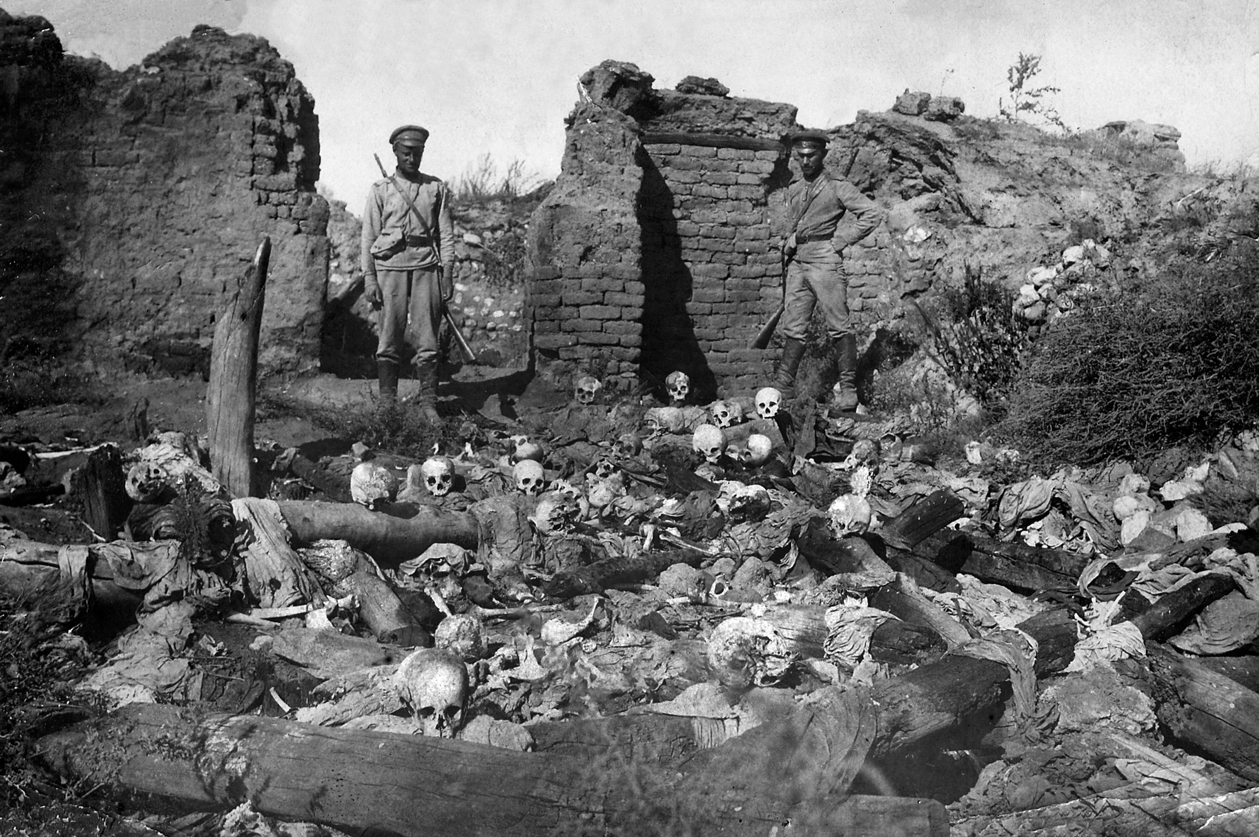 A photo dated 1915 purportedly shows soldiers standing over skulls of people from the Armenian village of Sheyxalan, on the Caucasus front during World War I.
