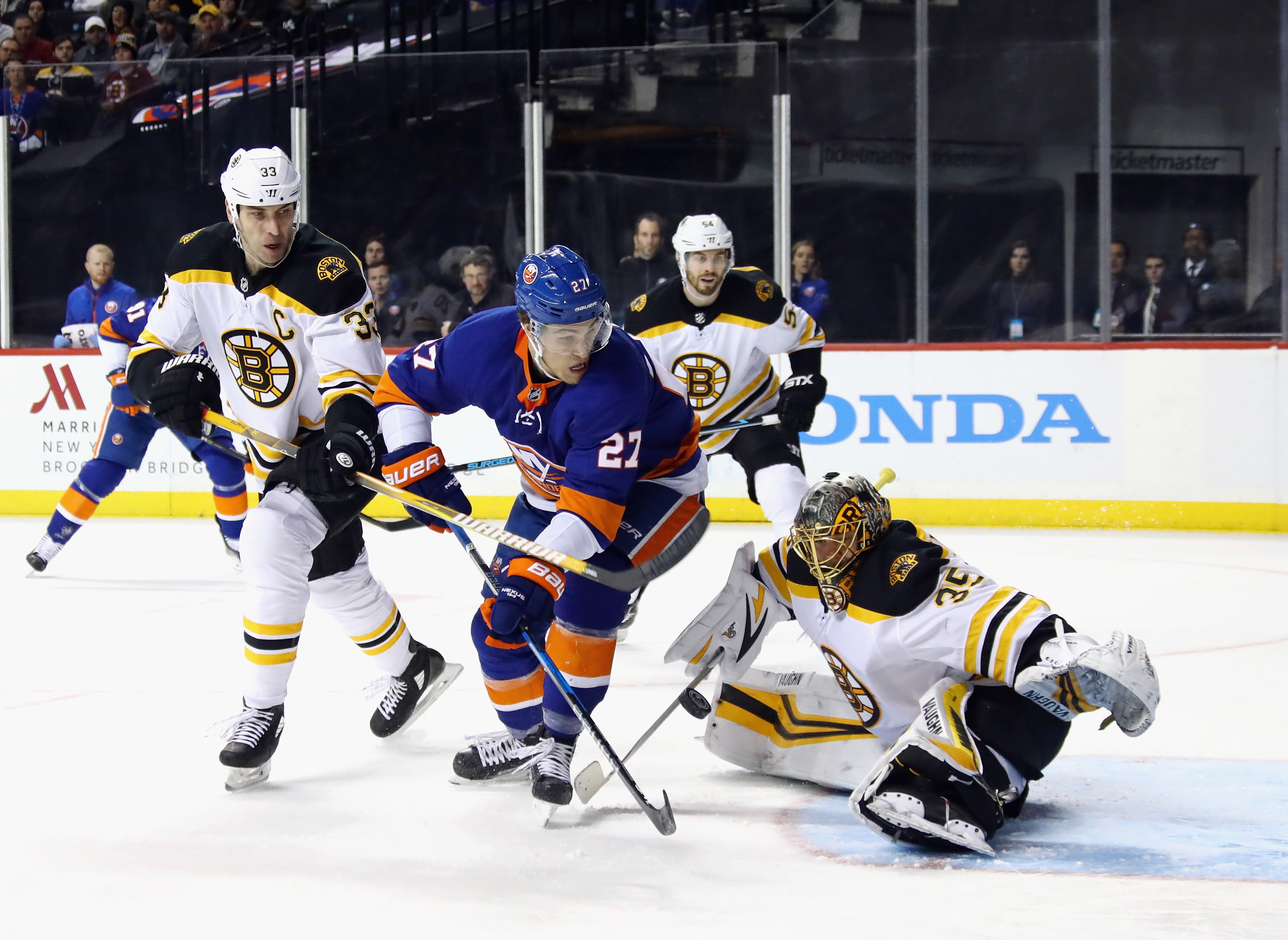 Zdeno Chara (left) and Anton Khudobin (right) defend against Anders Lee.