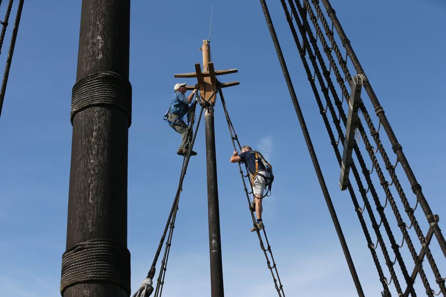 Peter Arenstam of Plimoth Plantation and volunteer Thomas Bott had duties high in the rigging on Wednesday.