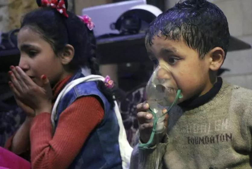 This image released early Sunday by the Syrian Civil Defense White Helmets shows a child receiving oxygen following an alleged poison gas attack in the rebel-held town of Douma, near Damascus, Syria.